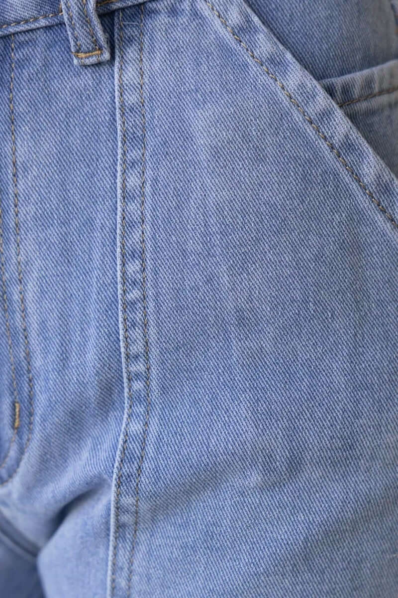 Close-up of light blue denim Madrid Jeans showcasing the cargo style, mid-high waist fit, and detailed stitching.