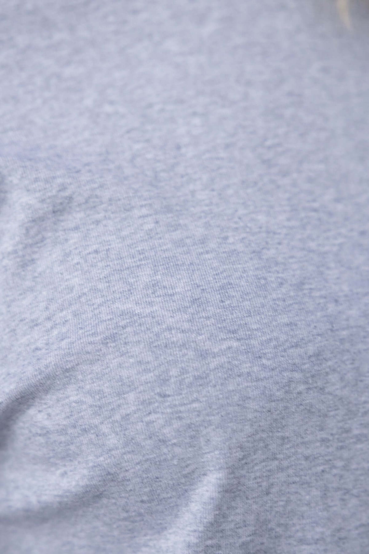 Close-up of the soft, stretch cotton fabric of the Minden Dress in light gray, highlighting its comfortable texture.