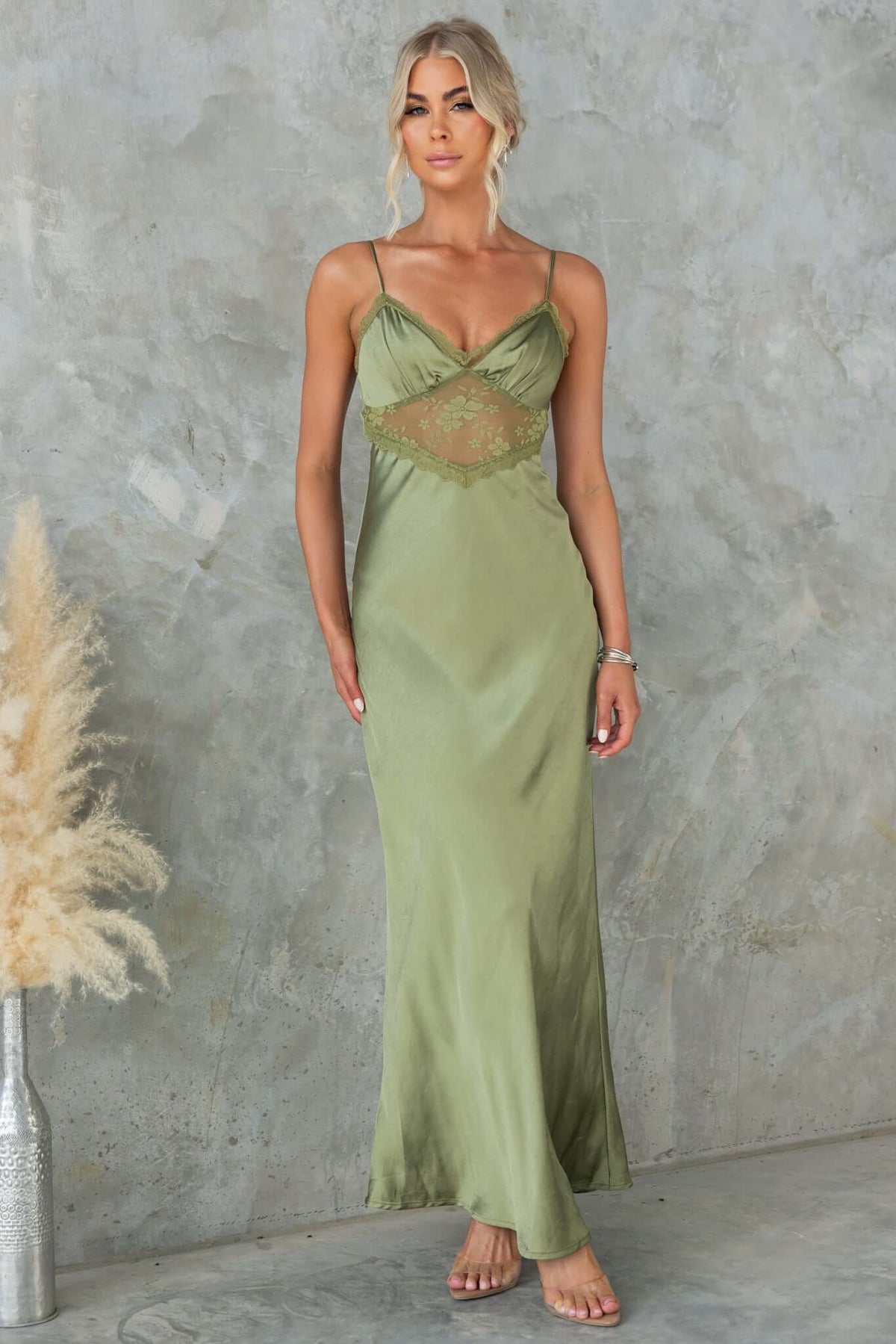 Obsidian Maxi Dress in olive green, featuring adjustable straps and lace panel, showcasing a stunning silhouette.