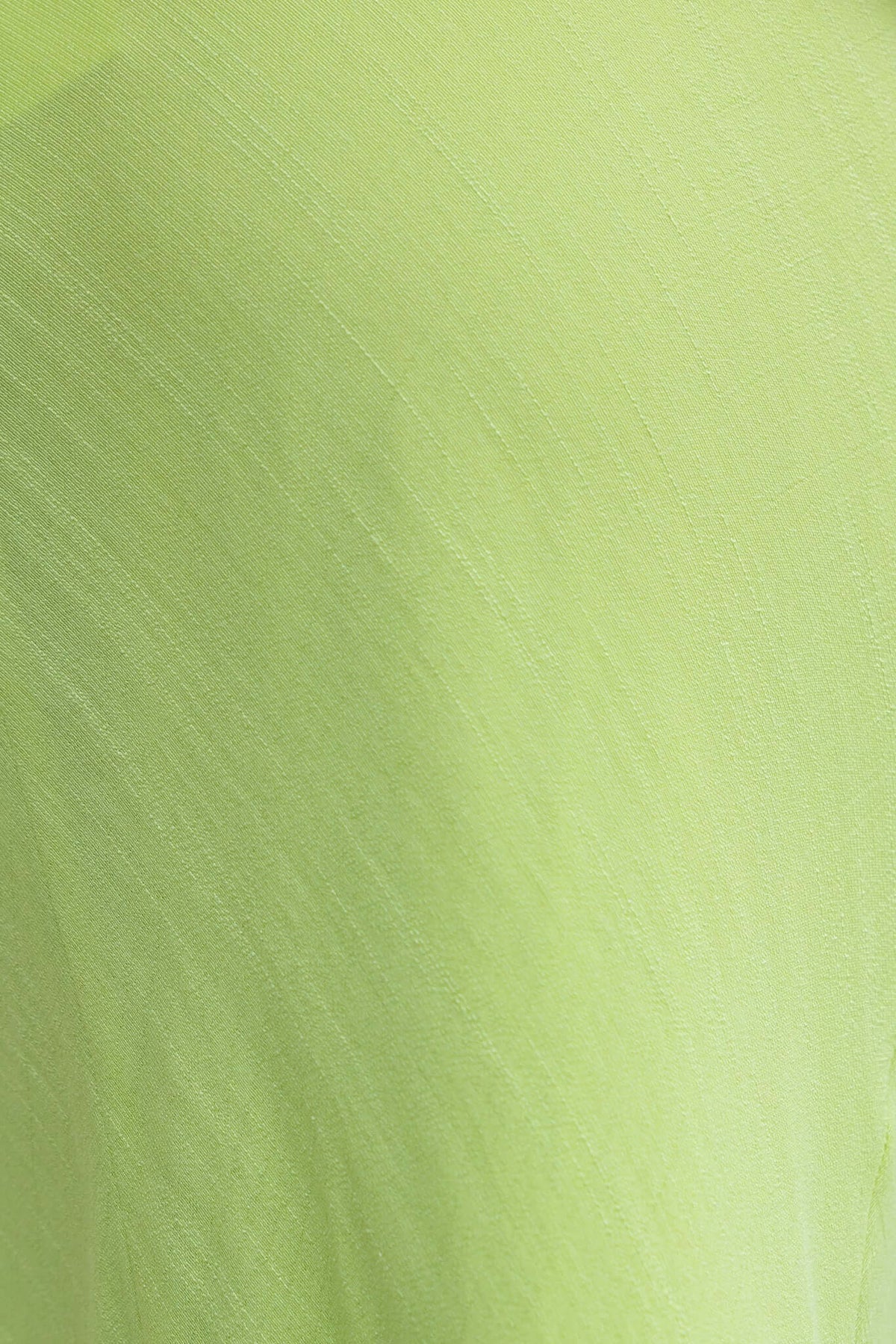 Close-up of light green chiffon fabric, showcasing its soft texture and sheen, ideal for elegant styles.