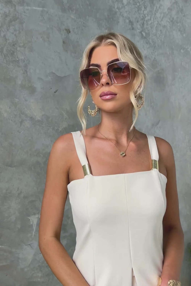 Model wearing Gette Top with adjustable straps and sunglasses, showcasing a stylish split and elegant design.