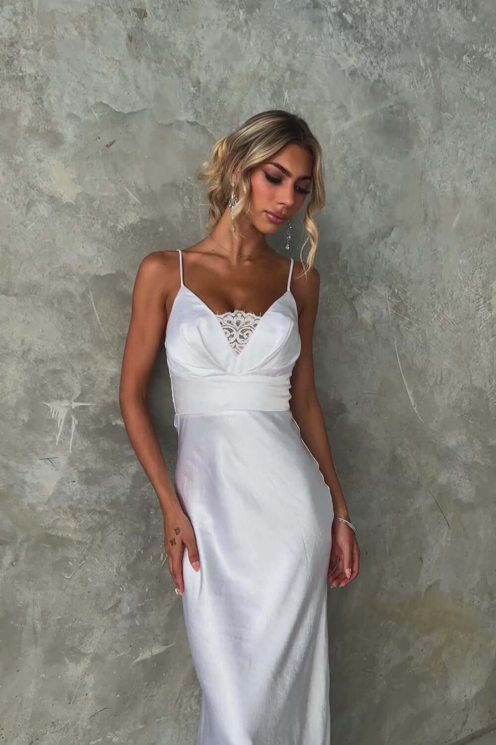 Model showcasing the Maricia Maxi Dress featuring adjustable straps and lace panel detail.