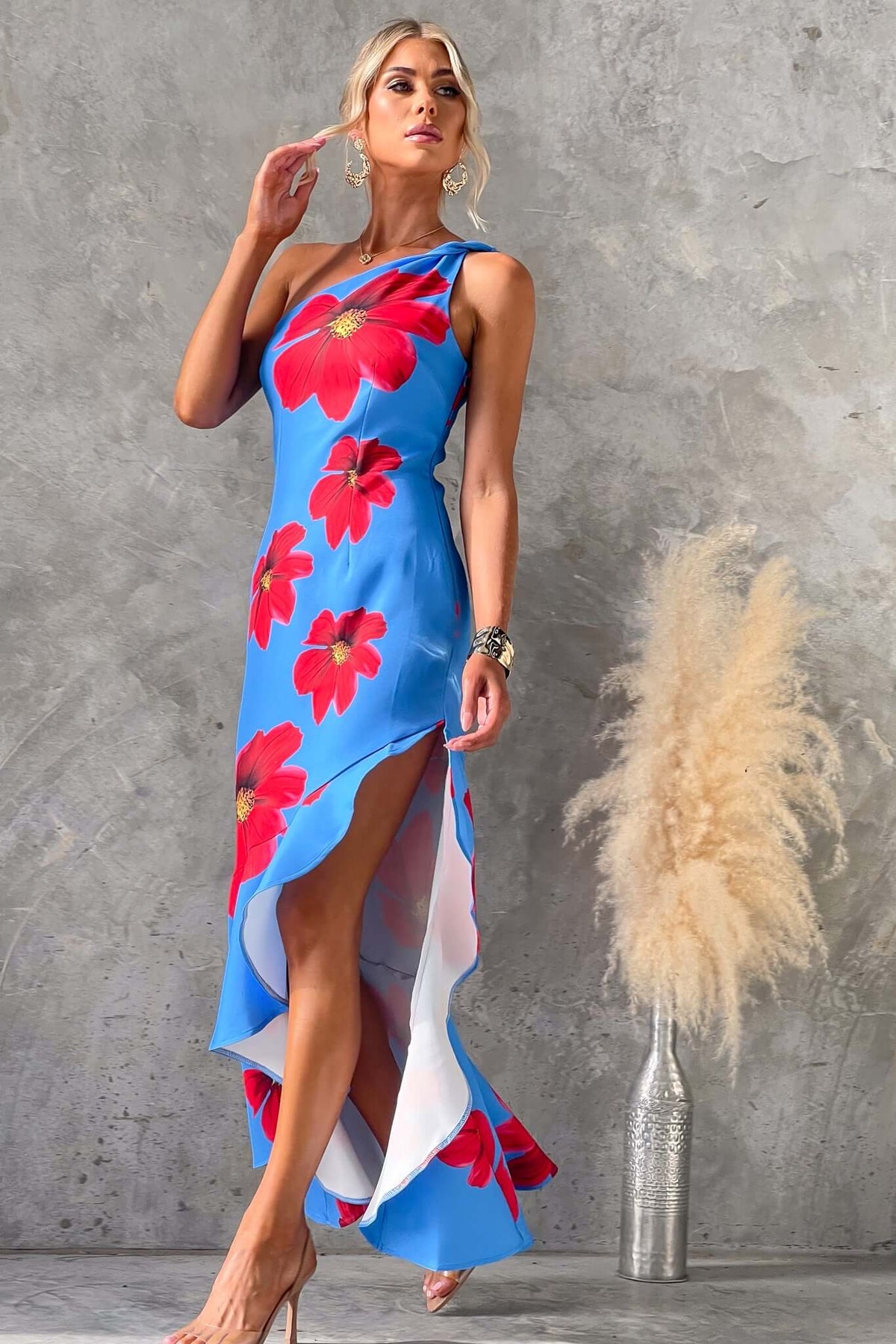 Model wearing Qonway Maxi Dress with blue floral design, one-shoulder neckline, and asymmetric hem.