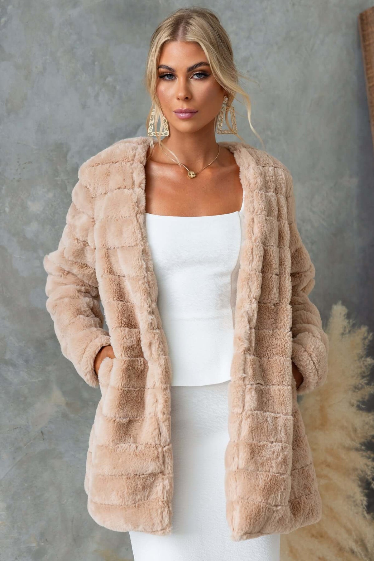 Quentin Faux Fur Jacket in beige featuring hook & eye fastening and a lined design, worn by model.