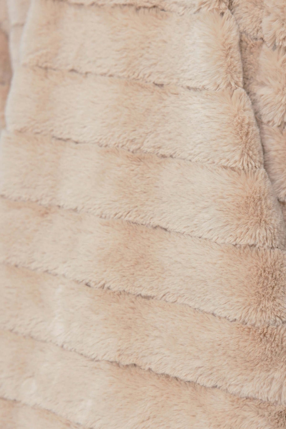 Close-up of the soft, textured faux fur of the Quentin Jacket, showcasing its plush, lightweight fabric.