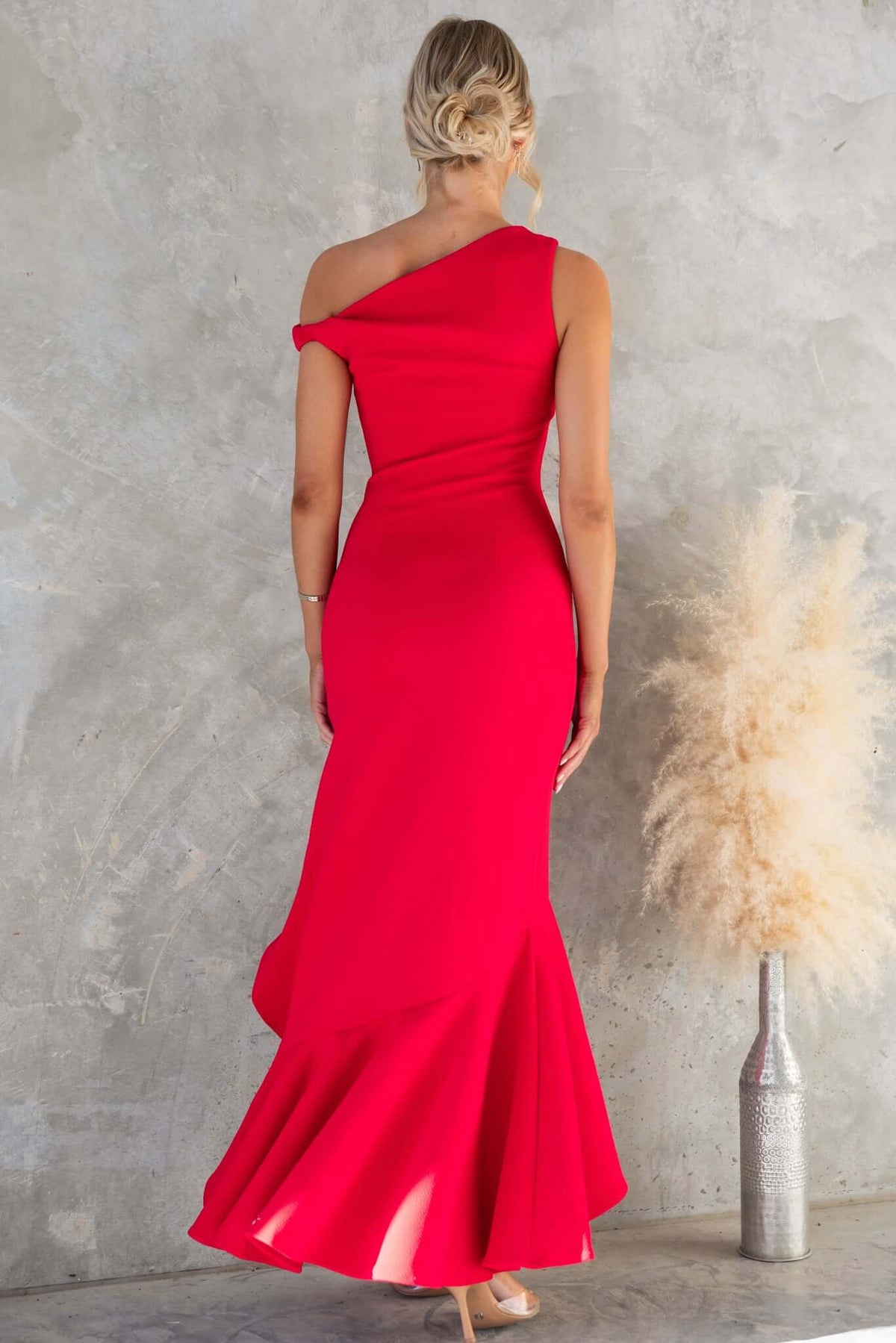 Raleigh Maxi Dress in vibrant red, featuring an asymmetric neckline and flared hem, perfect for special occasions.