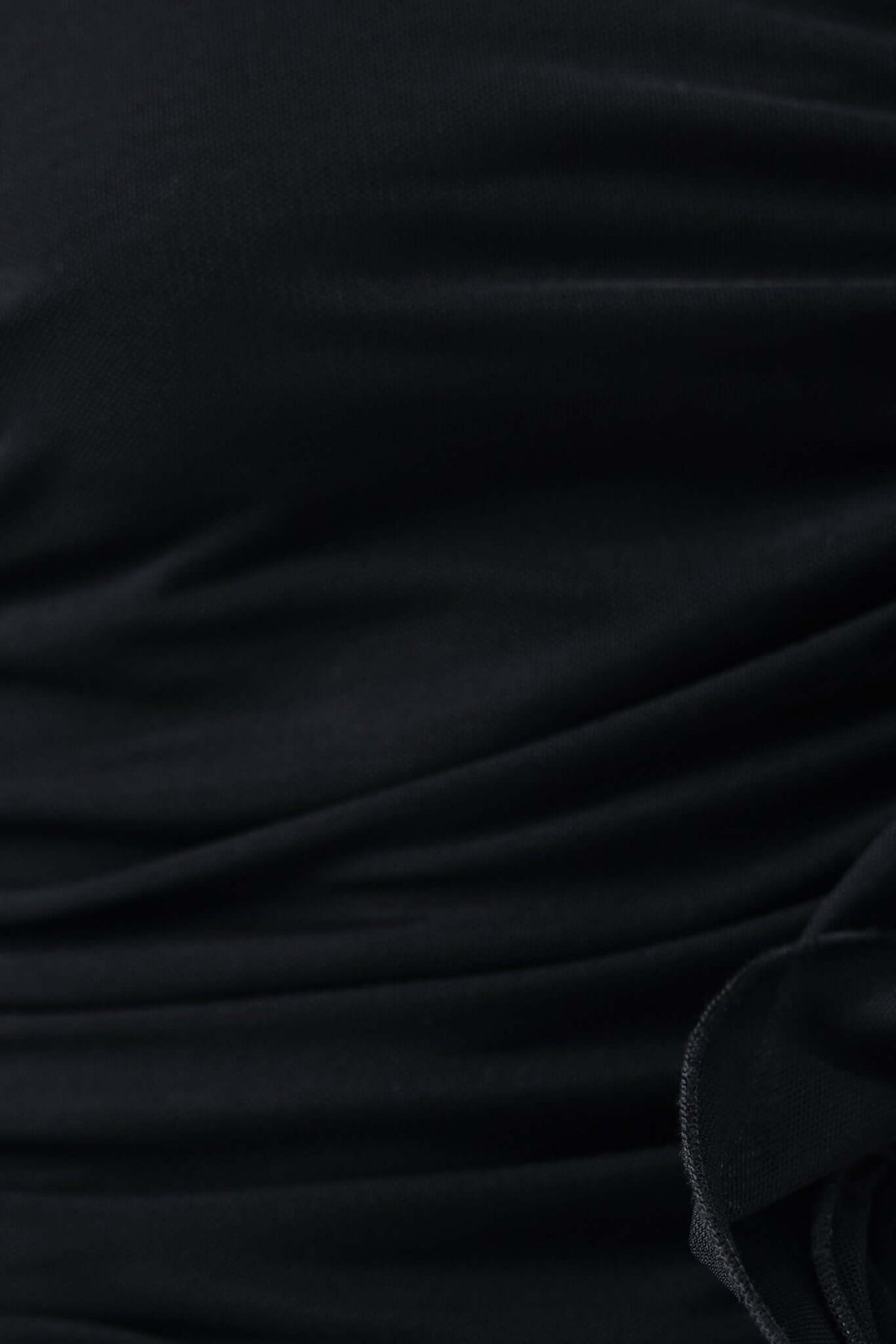 Close-up of the textured fabric of the Rehna Maxi Dress, highlighting the soft stretch material and elegant design.