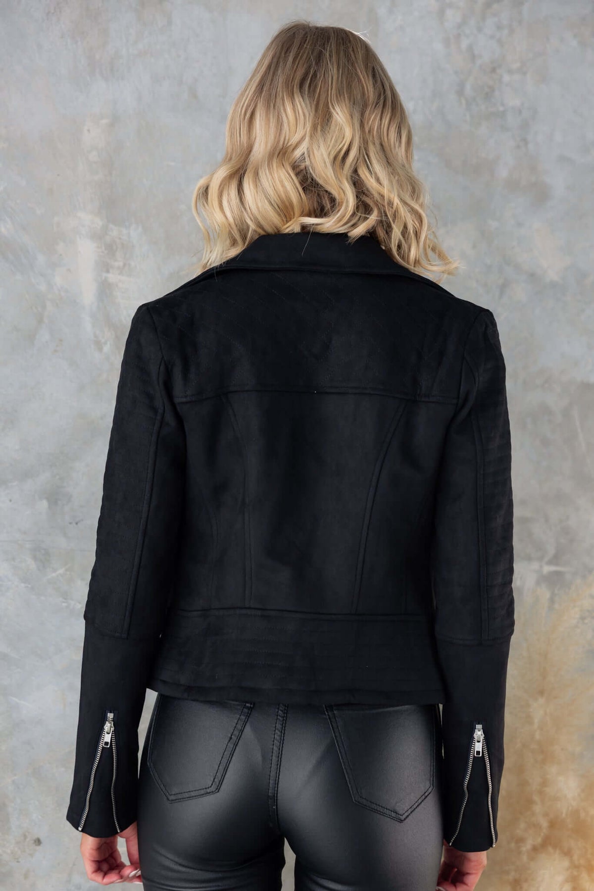 Model wearing the Remind Me Jacket in faux suede with a collar, zip detailing, and slant pockets from the back.
