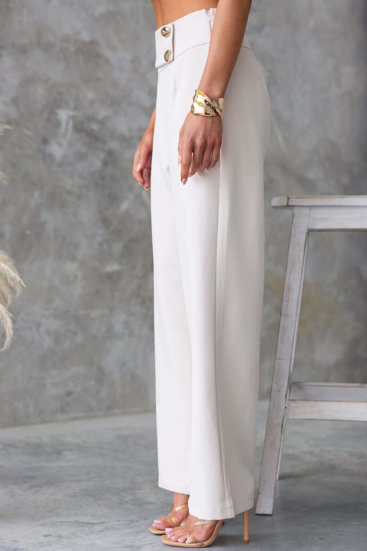 Side view of Roan Pants featuring mid-high waist, faux buttons, and a tailored fit in a neutral hue.