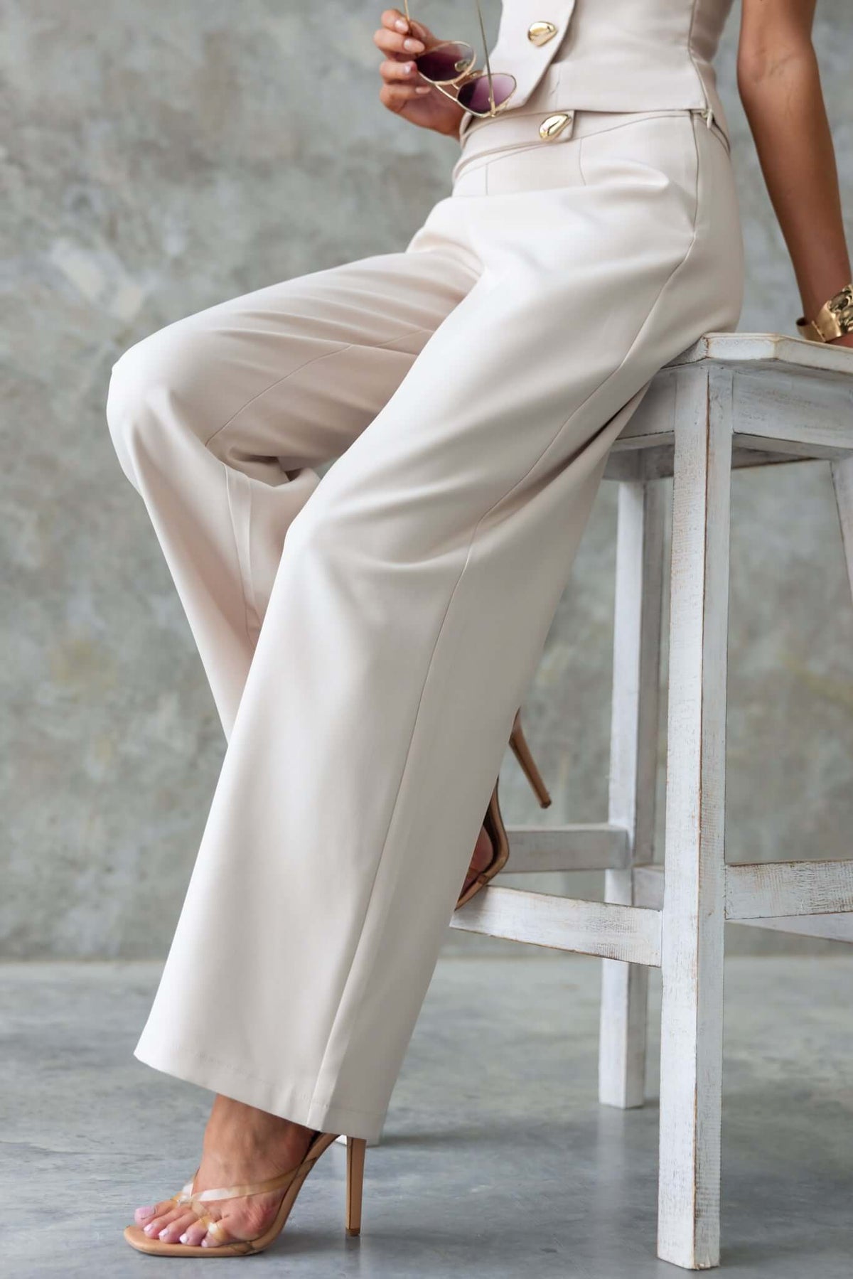 Stylish Roan Pants with mid-high waist, faux buttons, and a chic fit, showcasing neutral color and elegant design.