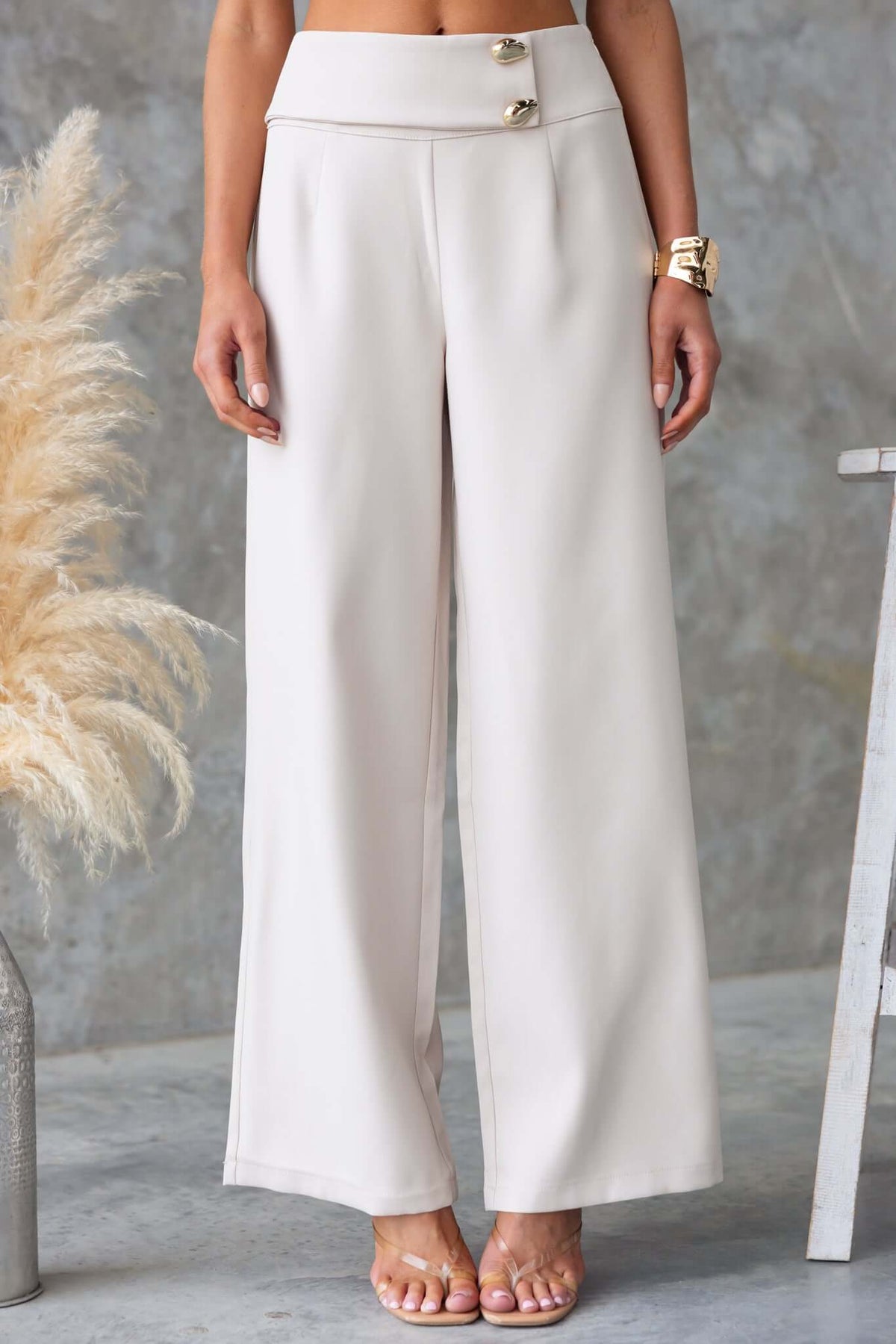 Beige Roan Pants with mid-high waist, faux buttons, and wide-leg fit, perfect for casual or dressy occasions.
