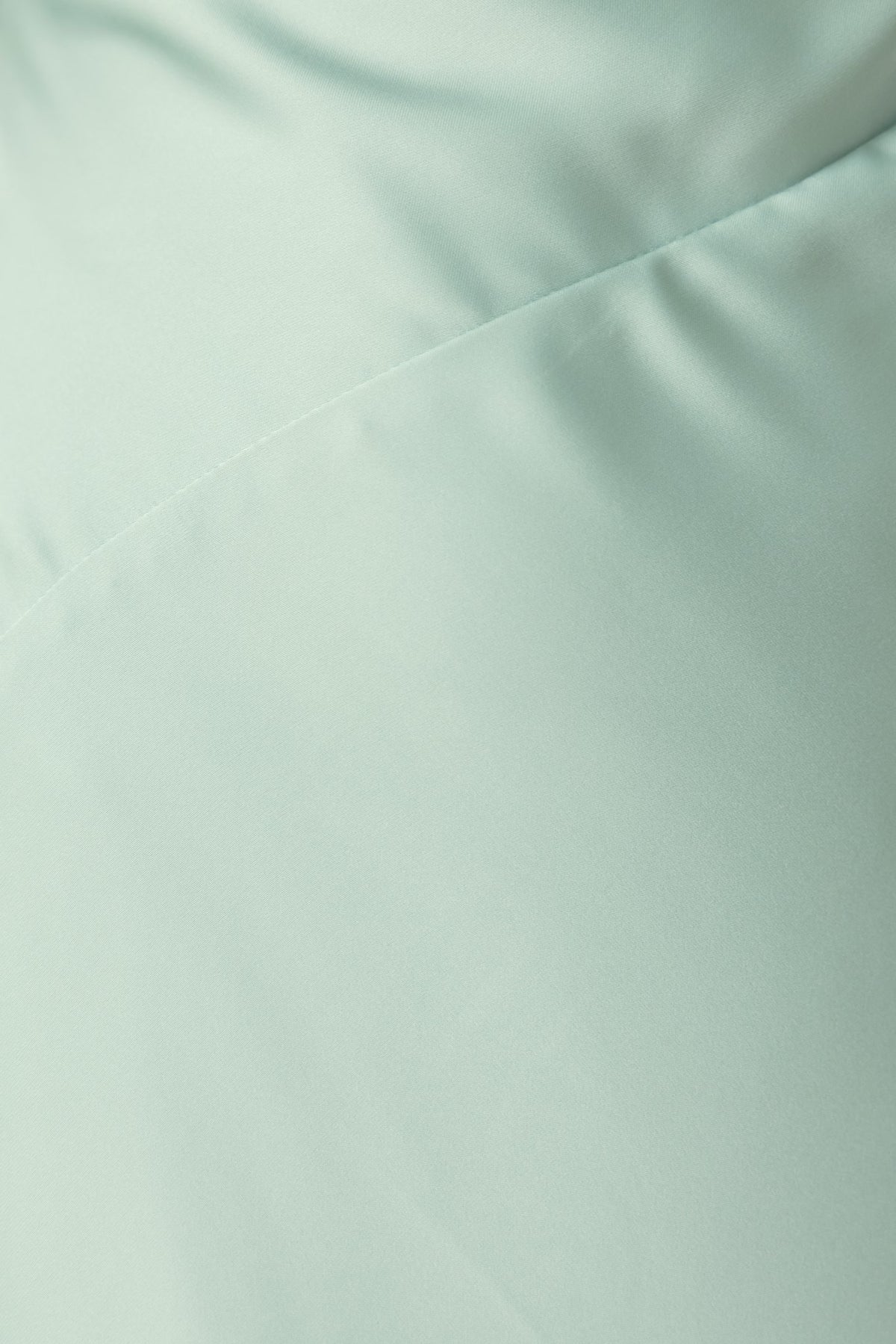 Close-up of the satin fabric in mint green of the Ronnie Maxi Dress by Amaroso Bridal.