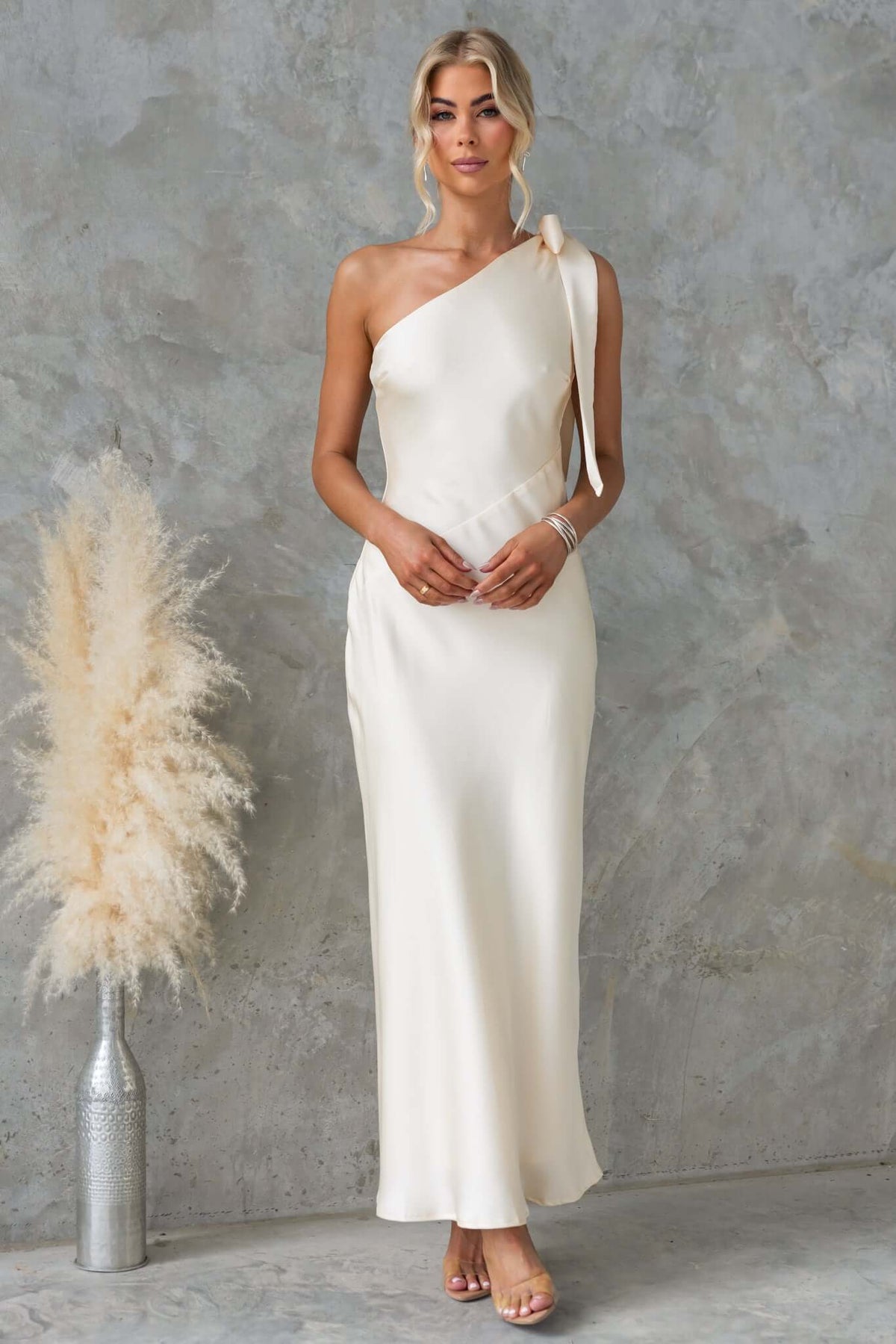Ronnie Maxi Dress features a one-shoulder tie neckline, satin material, and invisible side zip, perfect for elegant occasions.