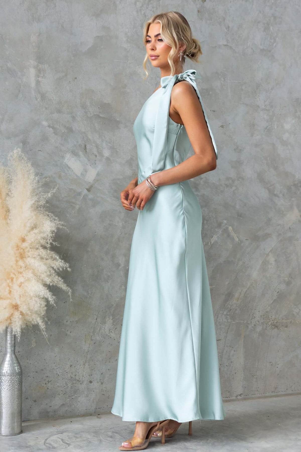 Ronnie Maxi Dress by Amaroso Bridal, featuring a one-shoulder tie neckline in mint satin, perfect for formal occasions.