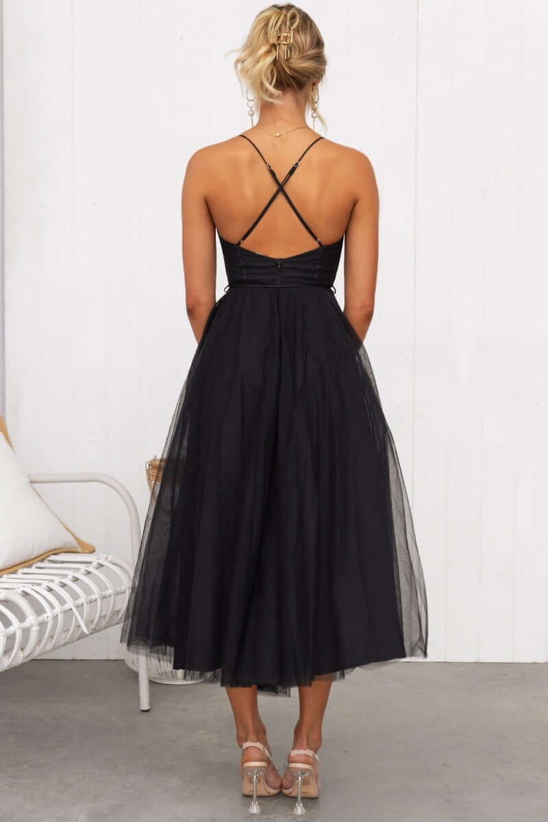 Back view of a black Florence Midi Dress featuring adjustable straps and a flowing tulle skirt.