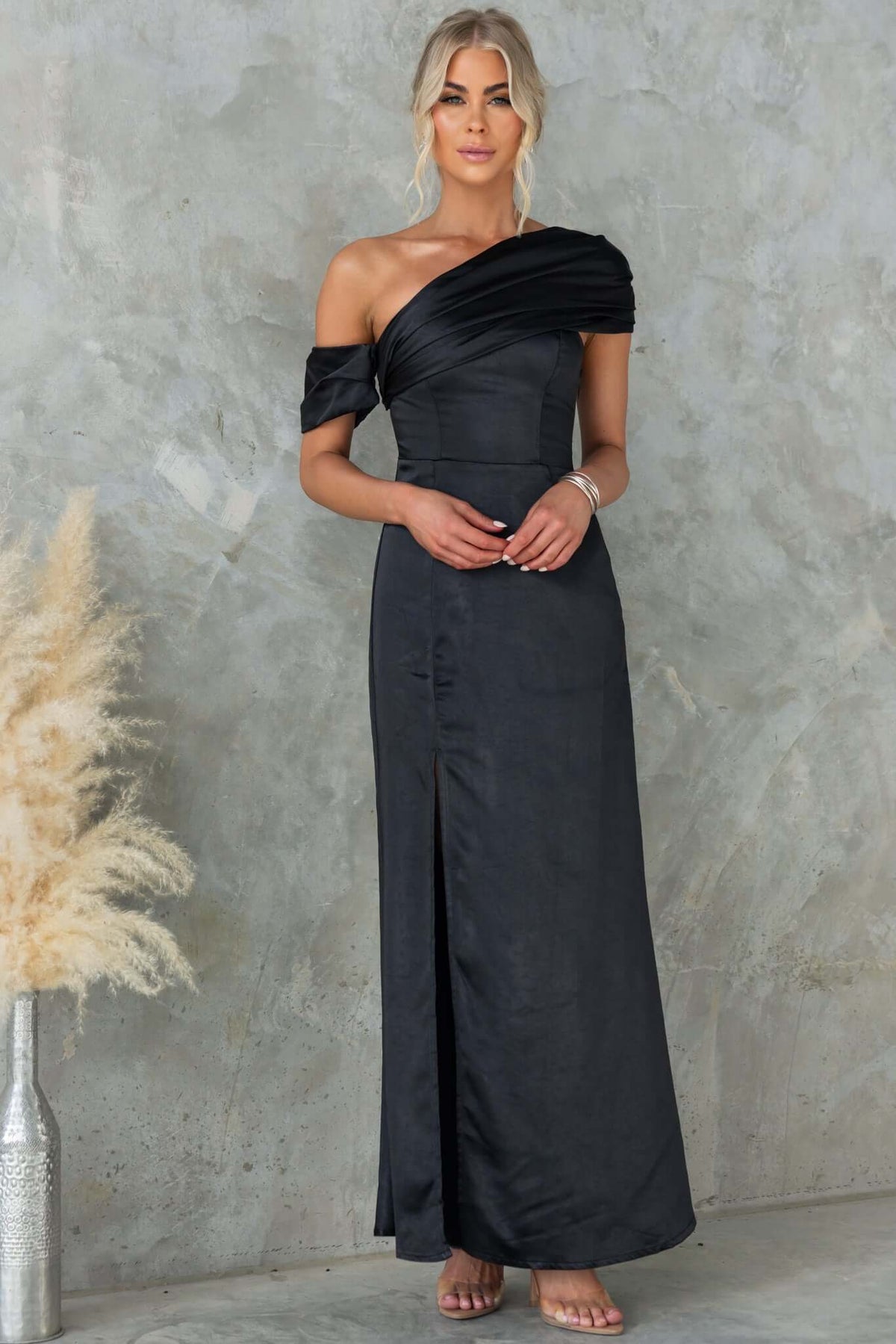 Stunning black Sonnet Maxi Dress featuring an asymmetric neckline, side split, and elegant satin material.