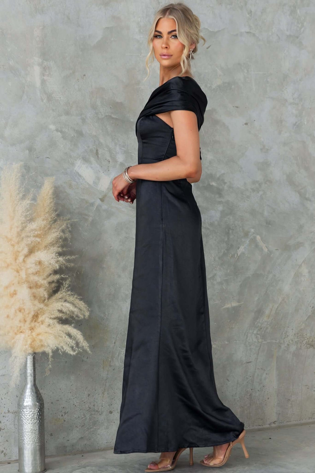 Model wearing the Sonnet Maxi Dress in satin material, featuring an asymmetric neckline and side split.