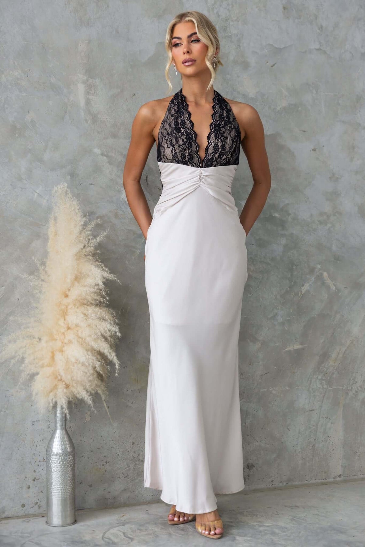 Elegant Sonrisa Maxi Dress featuring a lace bust and tie neckline, designed for a flattering fit and stylish look.