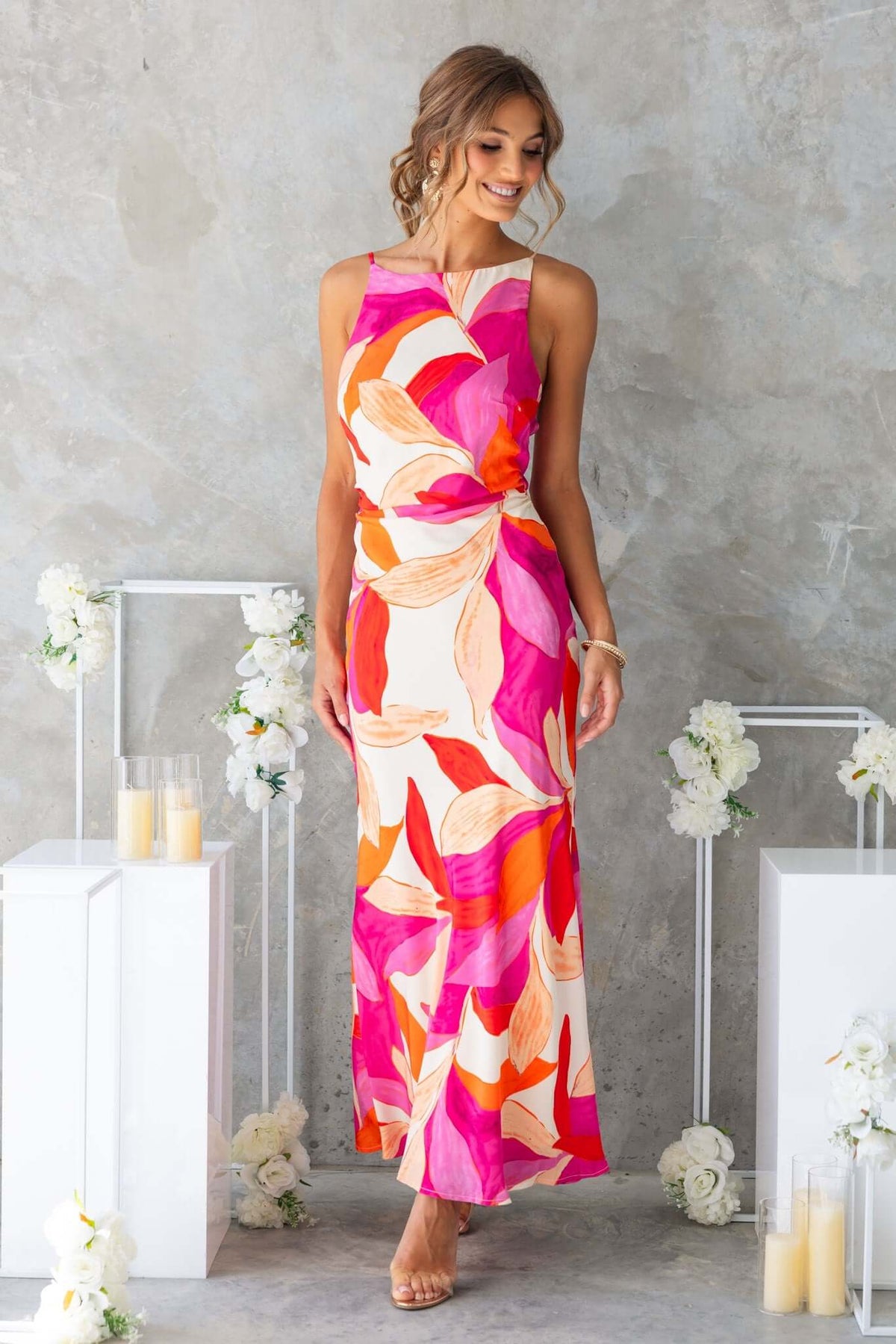 Model wearing Temptress Maxi Dress, featuring a floral pattern and high neckline, perfect for stylish occasions.