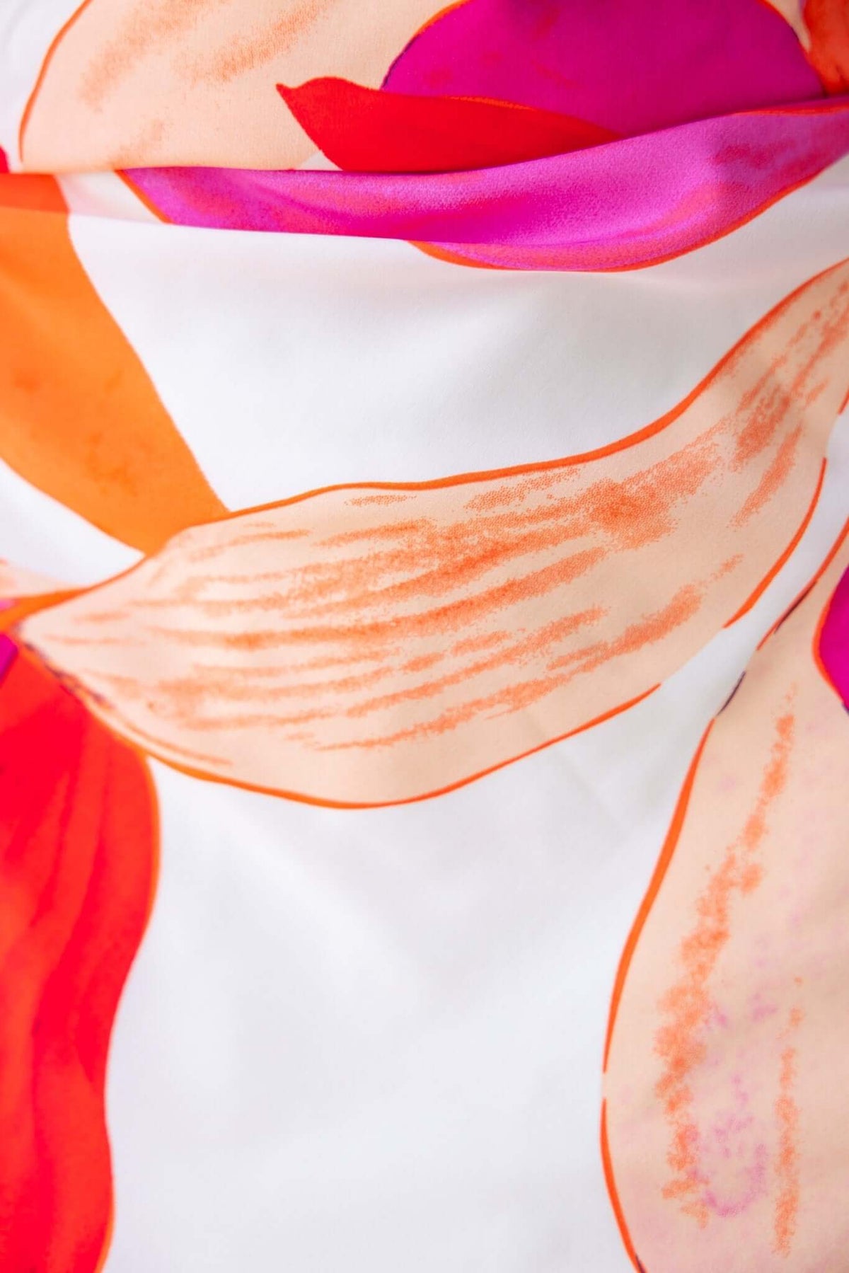Close-up of vibrant floral fabric in orange and pink shades, showcasing elegant design for Temptress Maxi Dress.