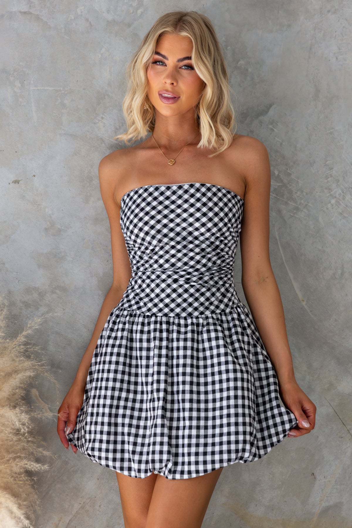 Toni Dress in black and white gingham, strapless design with bubble hem, perfect for summer outings.