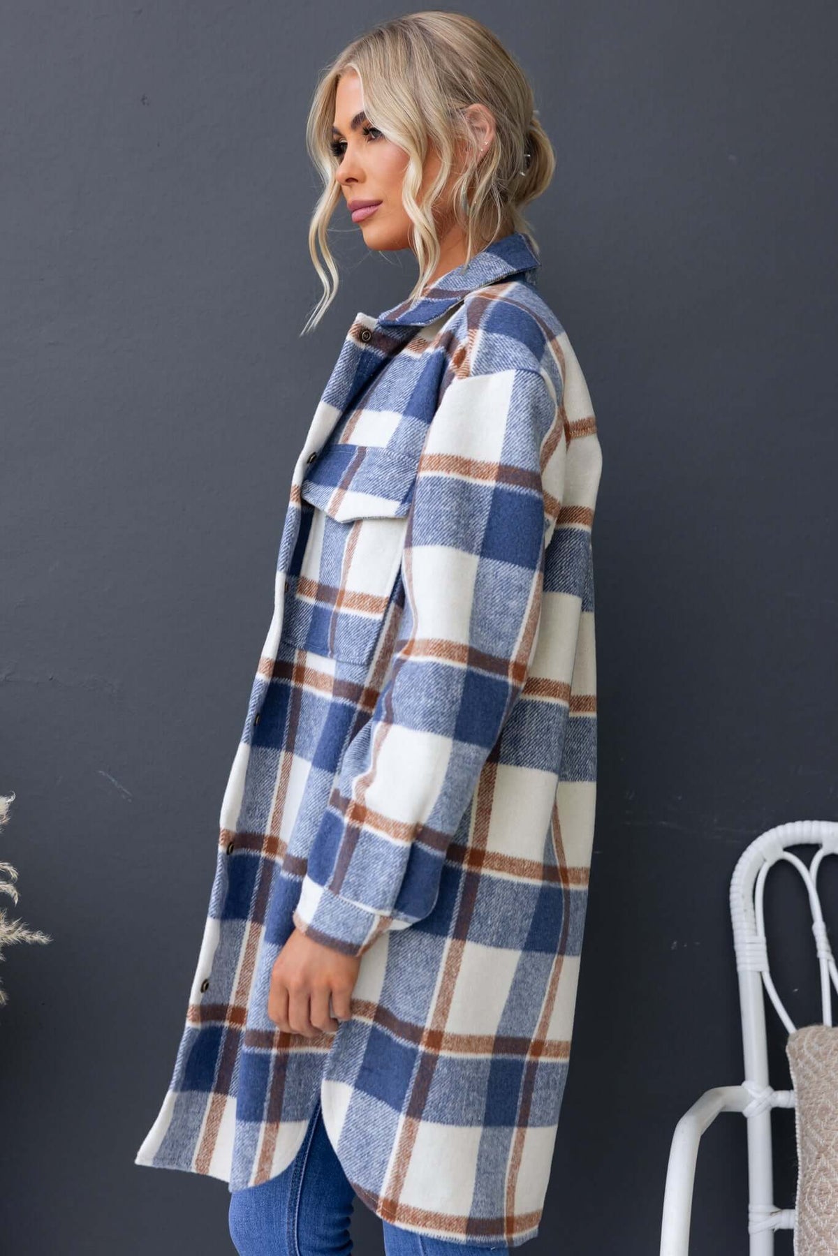 Model wearing a blue and white plaid Torres Shacket with a relaxed fit and button-up front, featuring chest pockets.