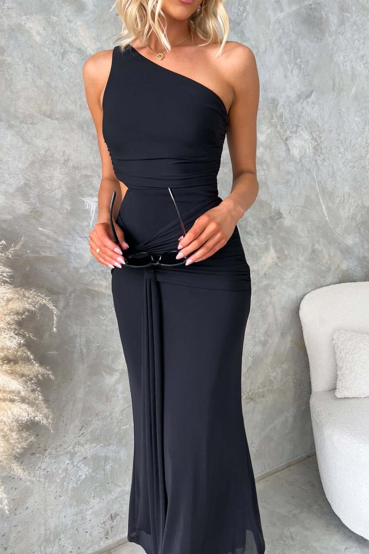 Stylish ultra maxi dress with one-shoulder neckline, cut-out waist, and mesh material, perfect for elegant occasions.