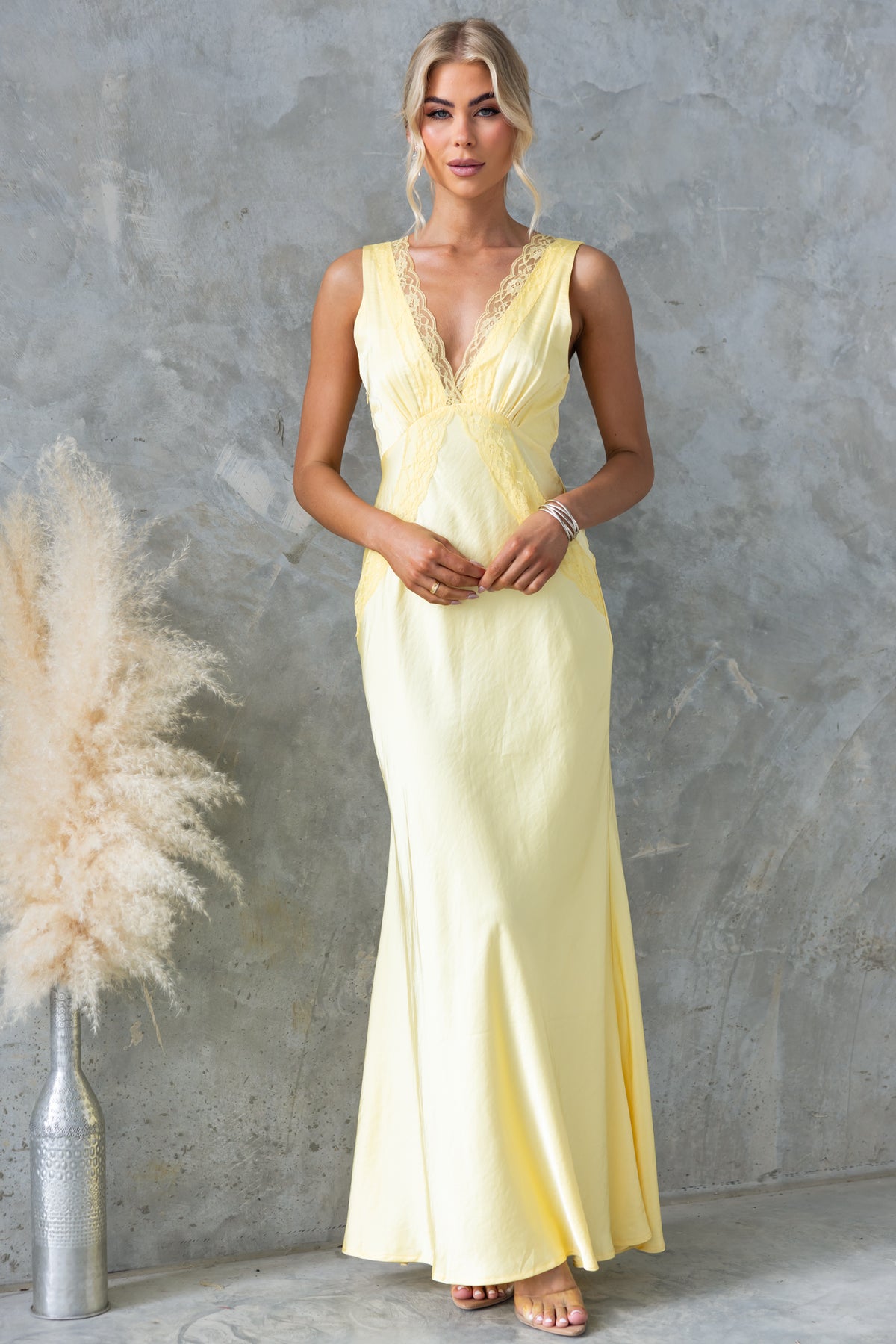 Uvira Maxi Dress in yellow satin with V-neckline and lace trim, perfect for special occasions.