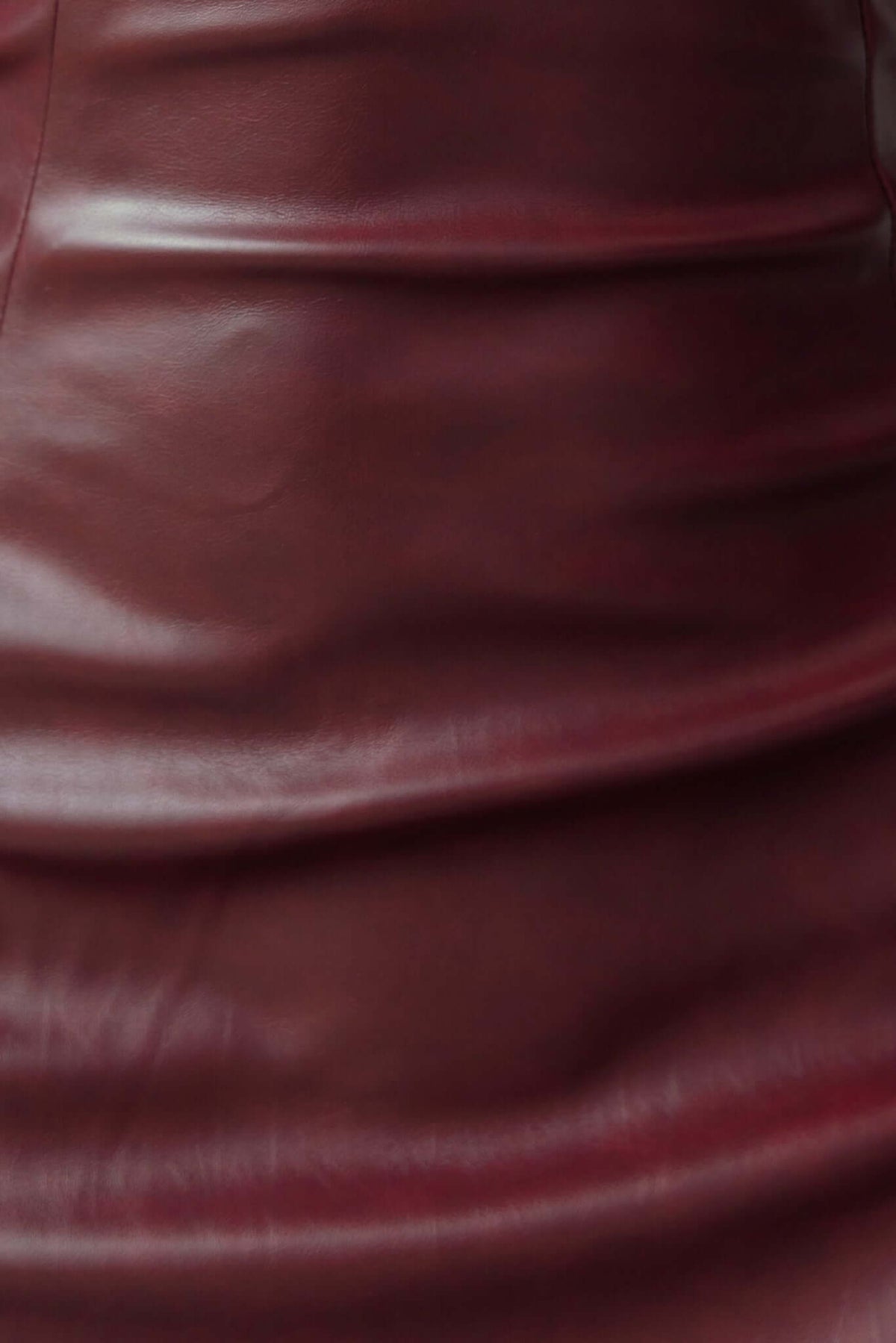 Close-up of faux leather material on Veridan Maxi Dress, showcasing its smooth texture and luxurious finish.