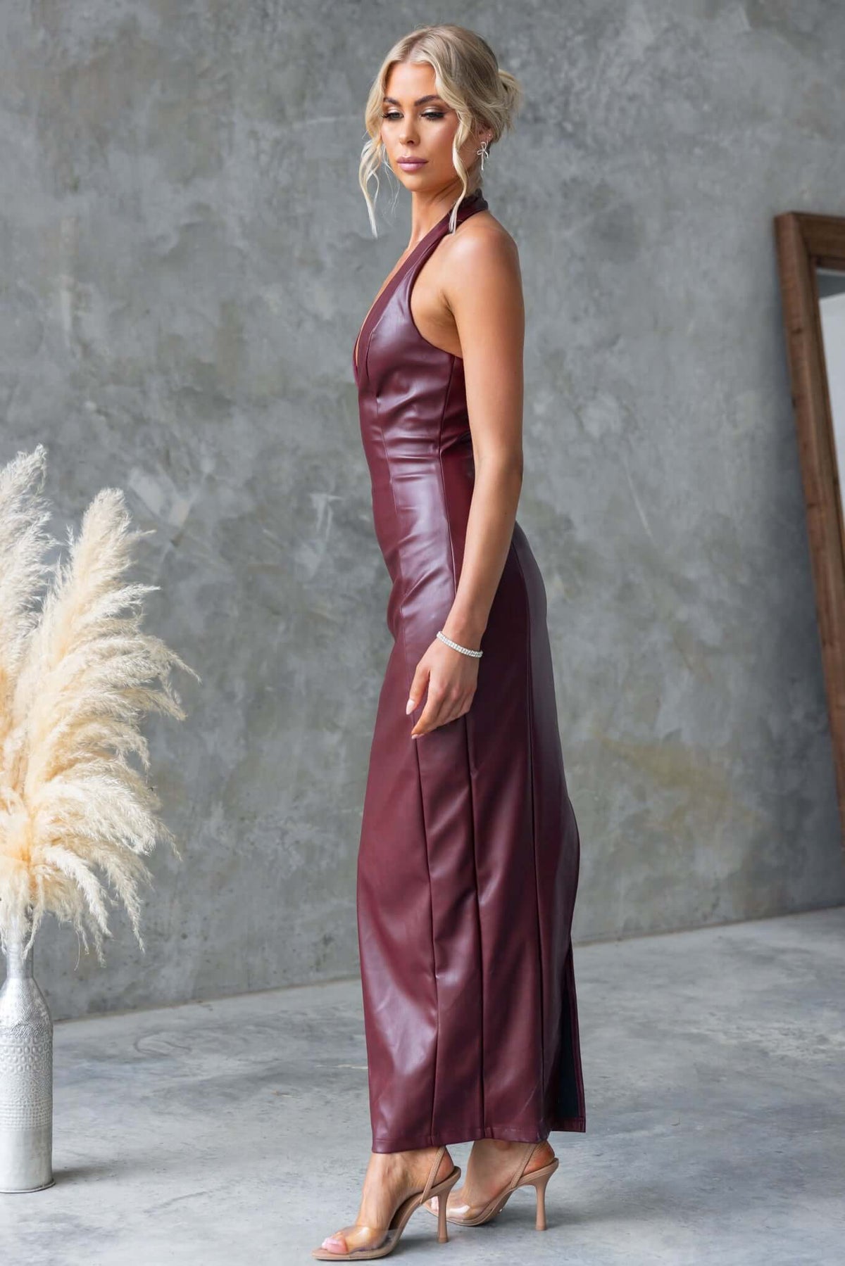 Elegant burgundy Veridan Maxi Dress featuring halter neckline, back split, and faux leather design.