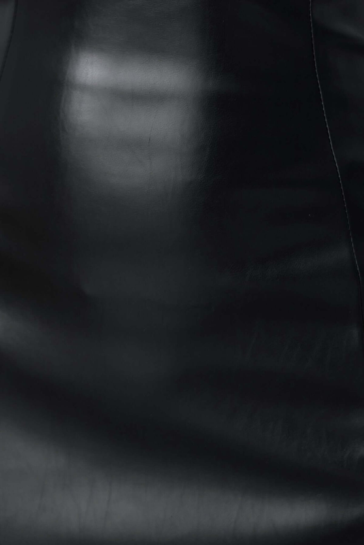 Close-up of black faux leather material for Veridan Maxi Dress, showcasing its sleek and shiny texture.