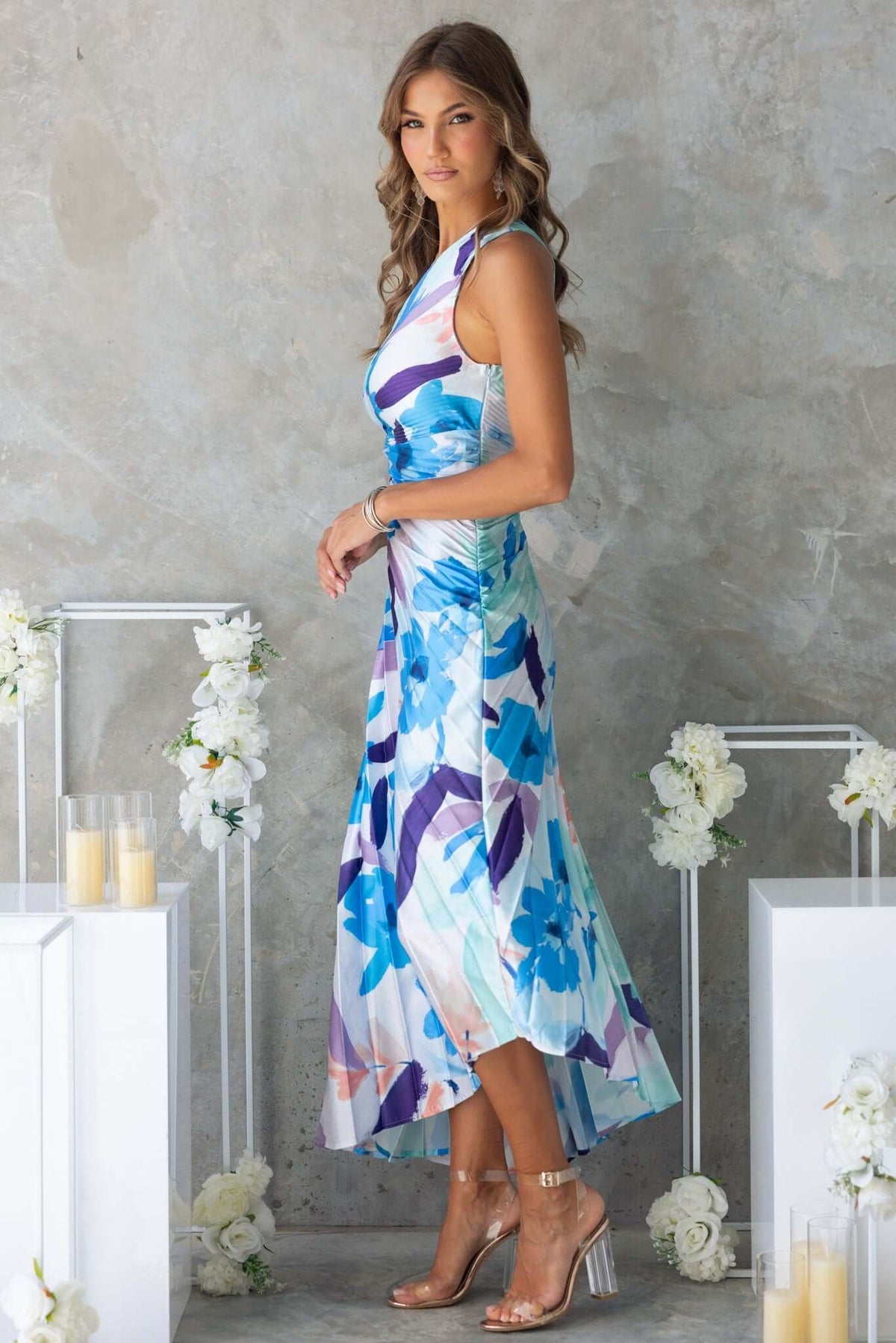 Model wearing Olympia Maxi Dress featuring a floral print, one-shoulder neckline, and elegant side slit.