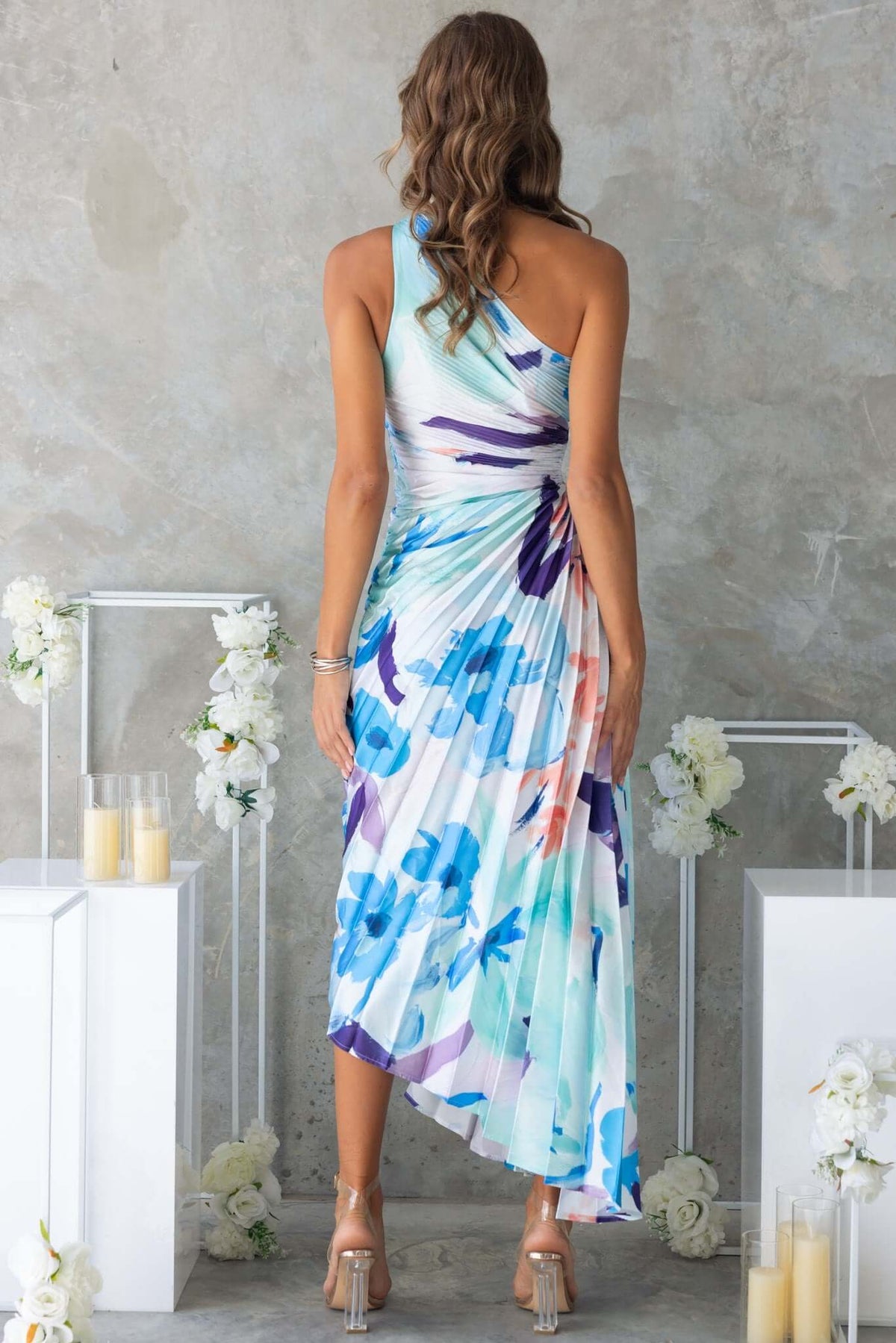 Back view of the Olympia Maxi Dress featuring a one-shoulder neckline and colorful floral print.