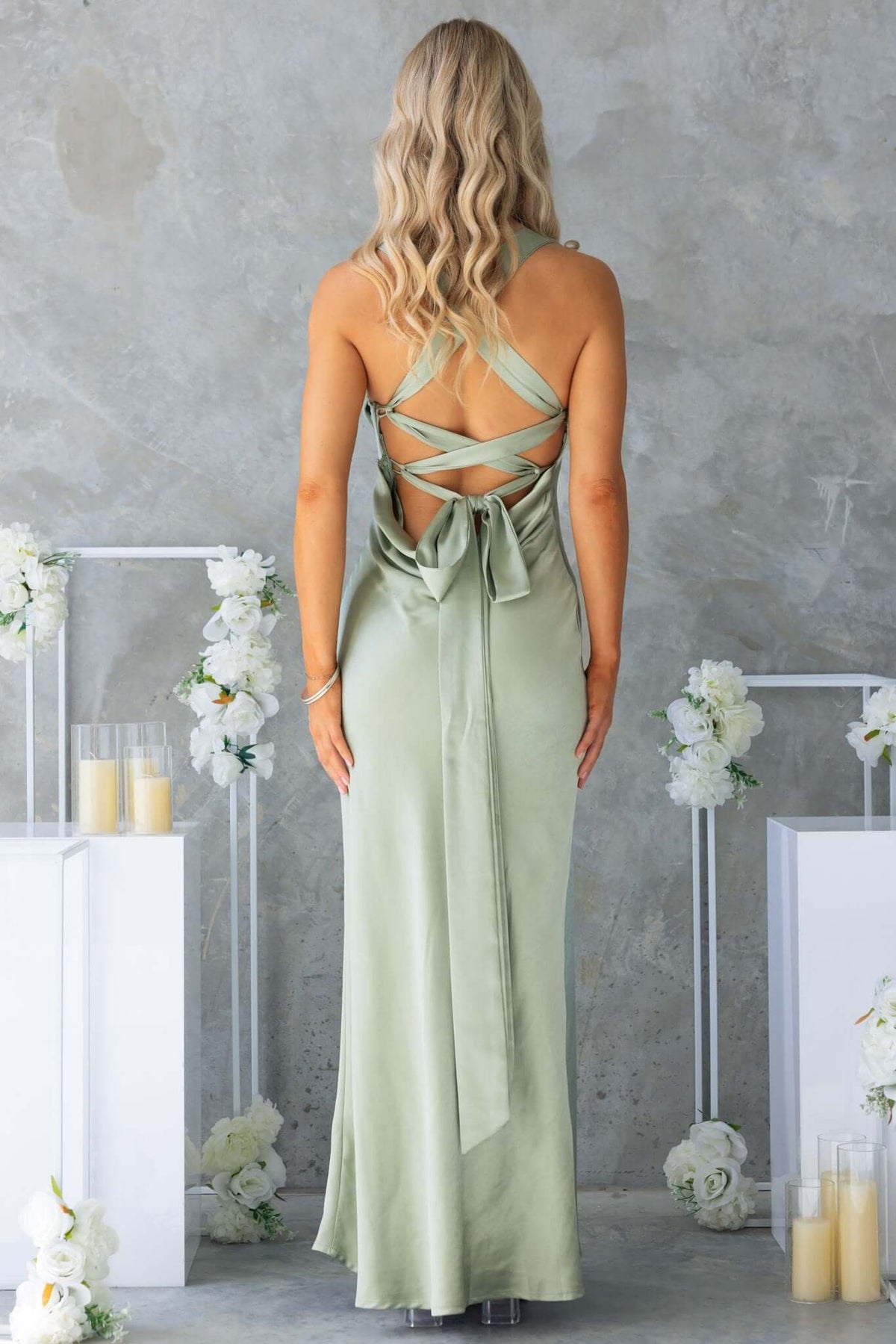 Rear view of Megan Maxi Dress in sage green, featuring adjustable tie straps and elegant back detail.