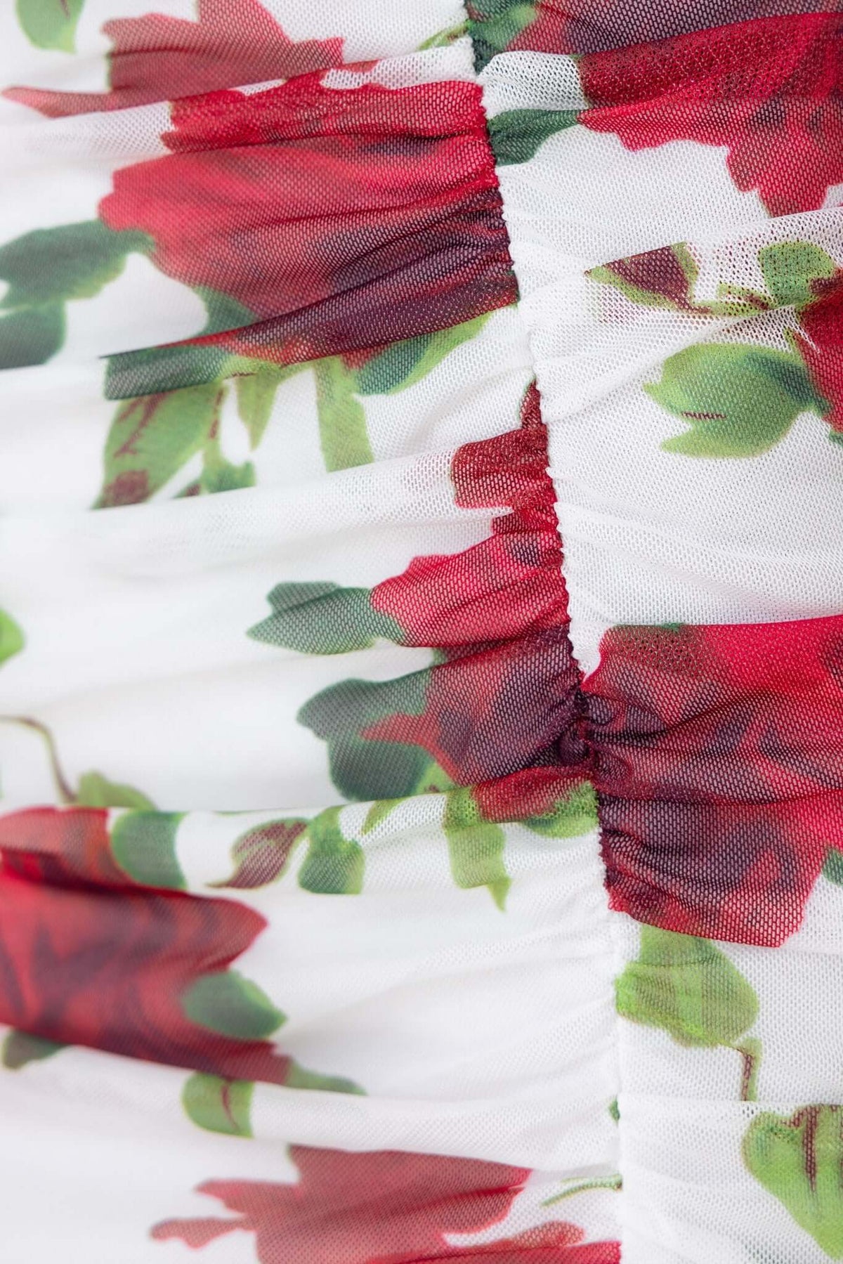 Close-up of floral pattern with red roses on a white mesh fabric from the Valentine Maxi Dress.