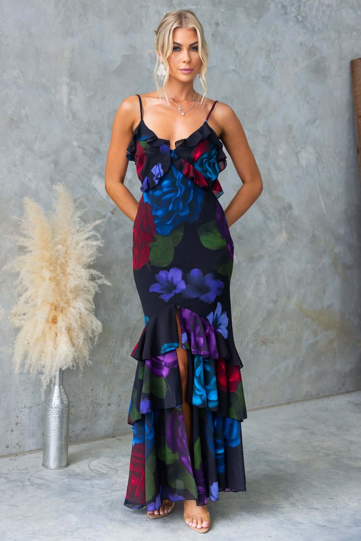Floral black maxi dress with adjustable straps and ruffles, perfect for summer elegance.