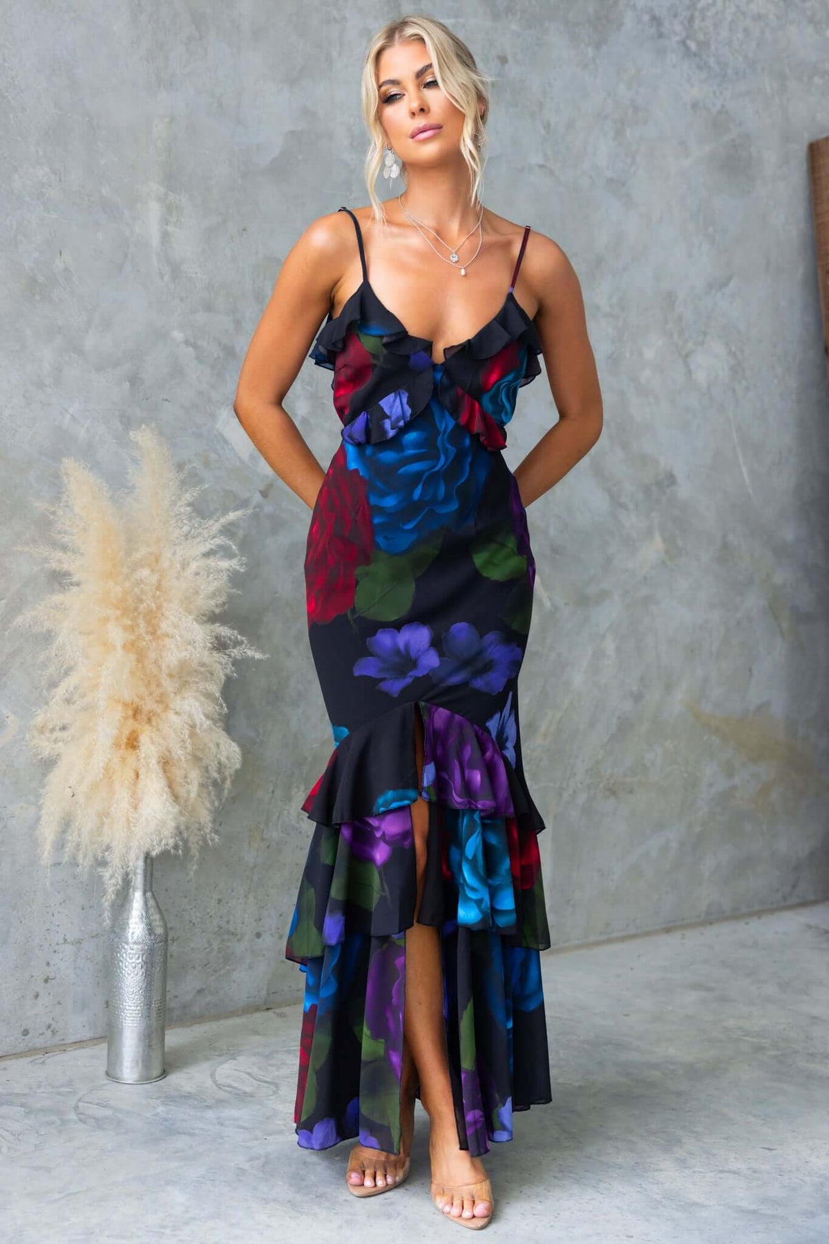 Elegant floral maxi dress with adjustable straps and ruffles, perfect for summer occasions.