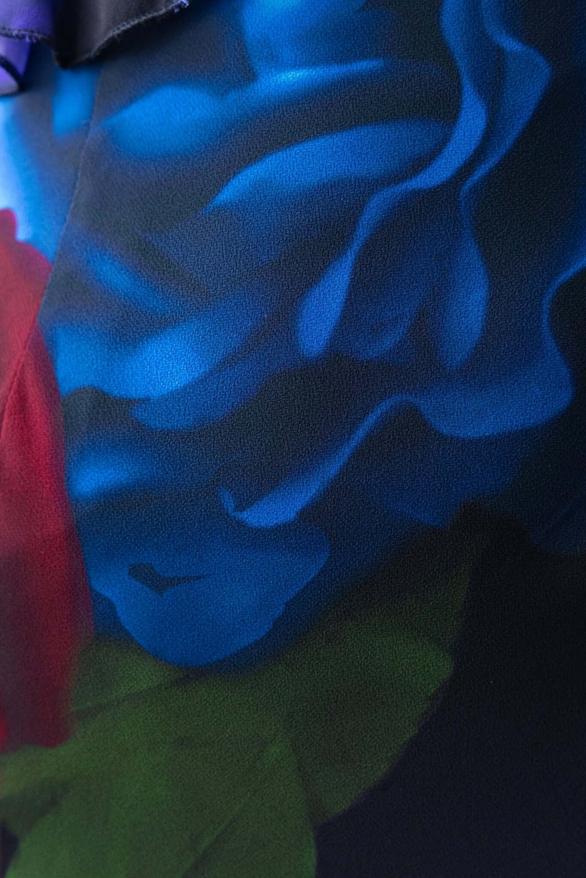 Close-up of vibrant blue and red floral print on chiffon fabric of the Vestige Maxi Dress, showcasing its elegant design.