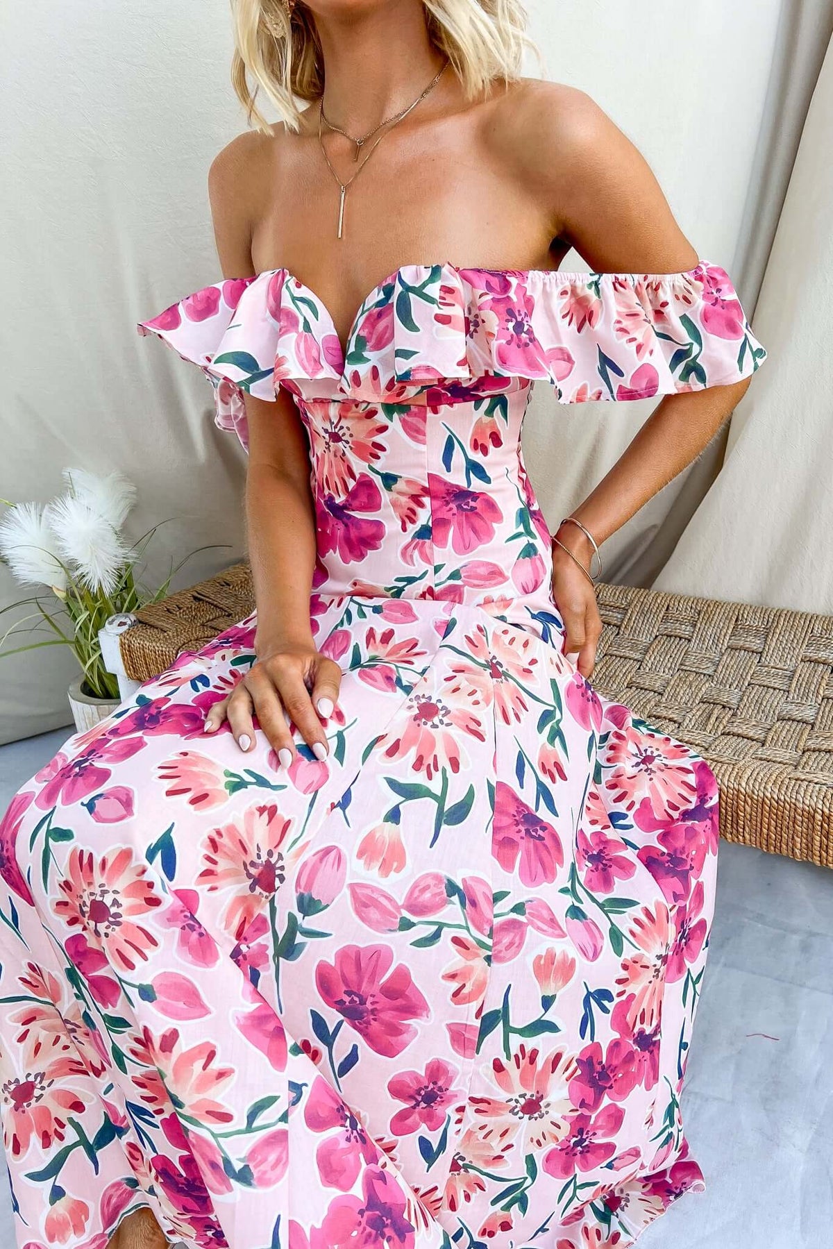 Wilma Maxi Dress featuring floral print, off-shoulder ruffles, and vibrant colors. Perfect for summer occasions and casual outings.