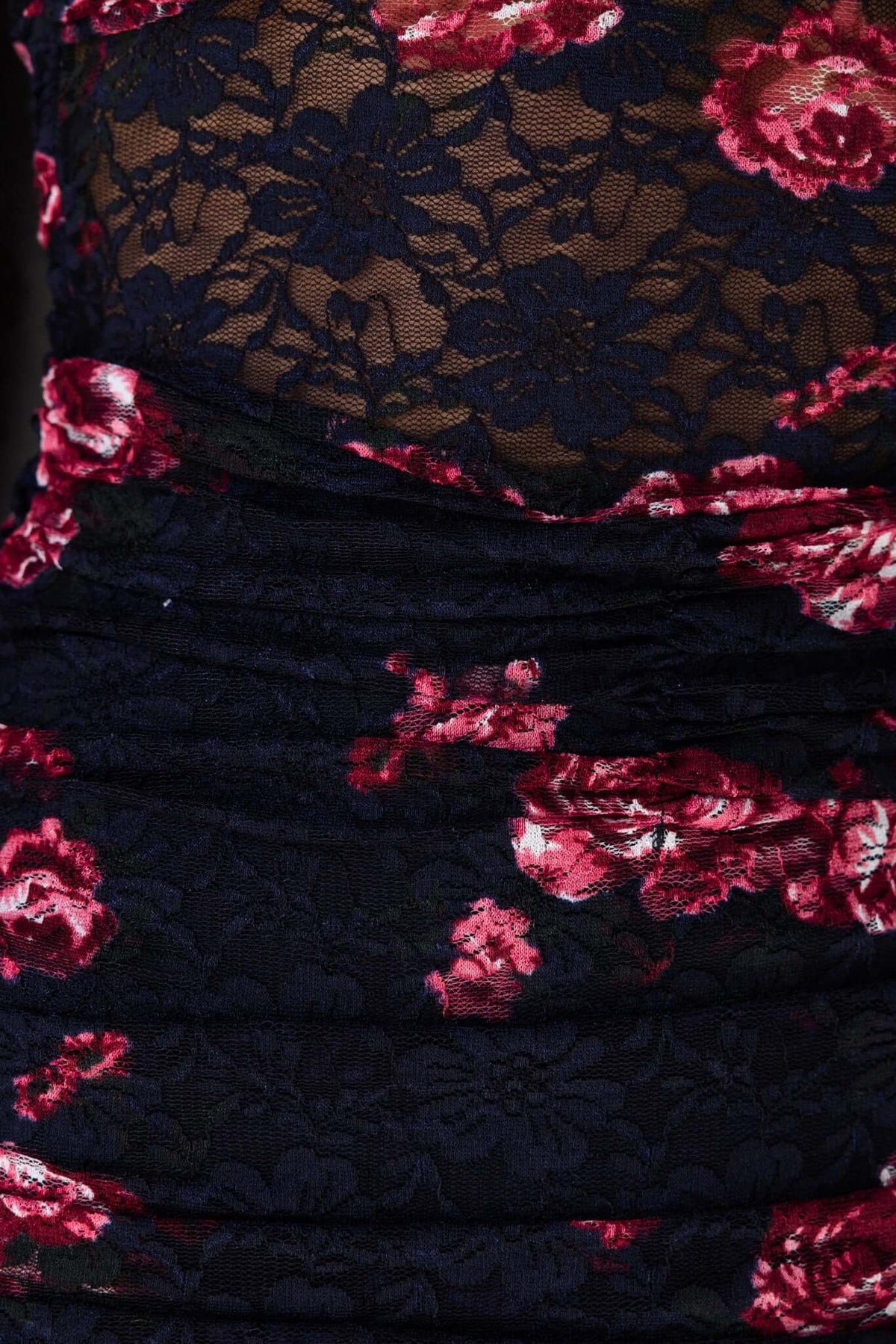 Close-up of Xavina Maxi Dress showcasing navy floral lace fabric with ruching and twist detail.