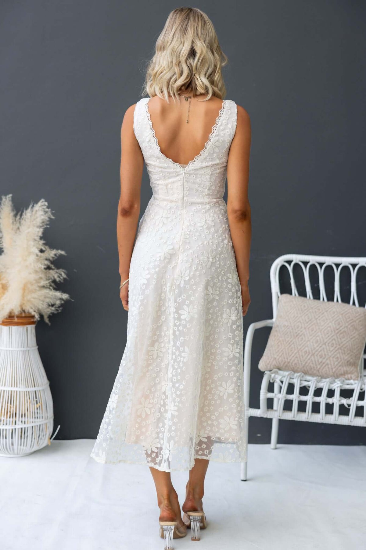 Back view of Yakima Midi Dress featuring a twist at the bust and an elegant lace design.