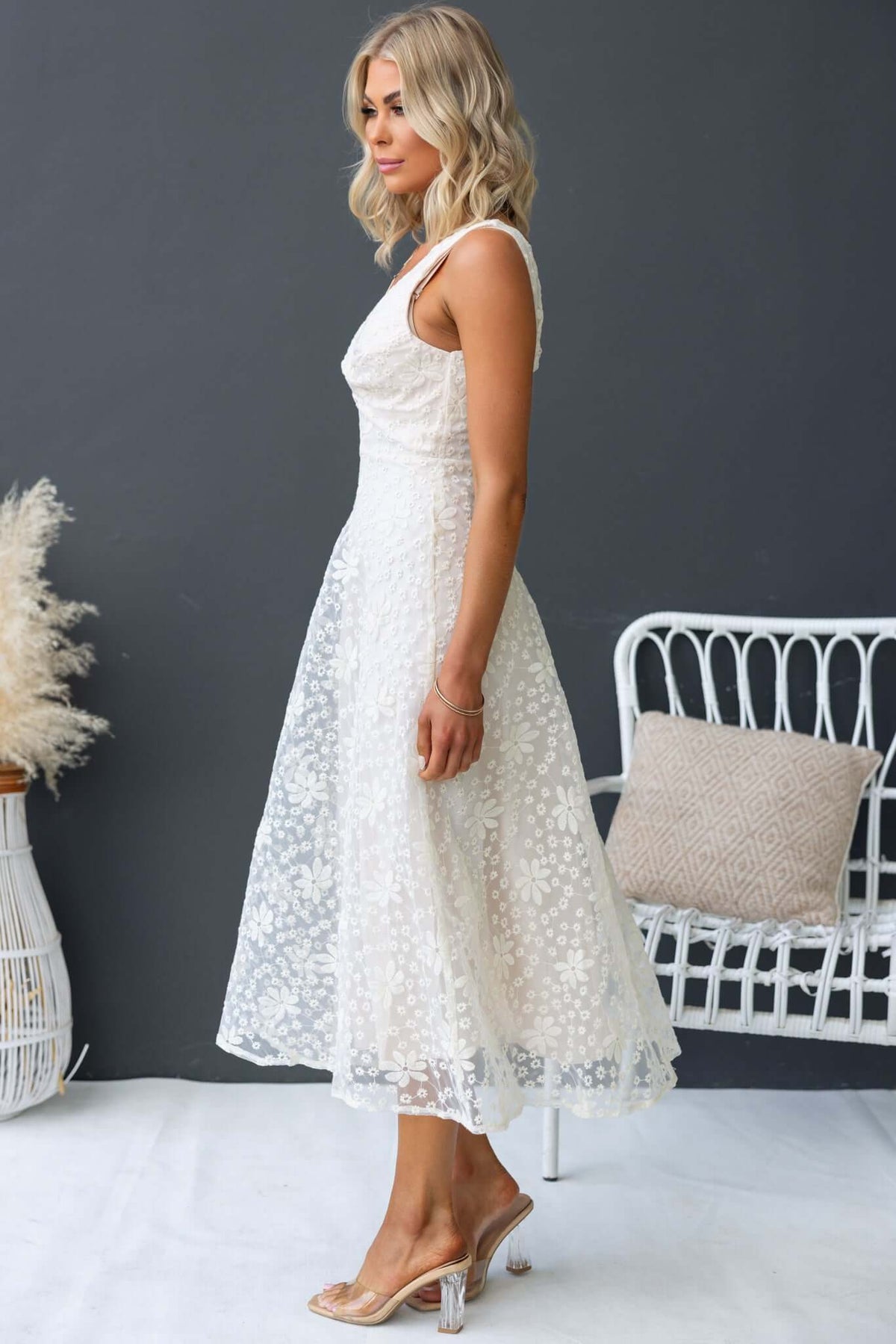 Side view of Yakima Midi Dress, featuring a floral patterned lace design and a fitted bodice with a flattering midi-length skirt.
