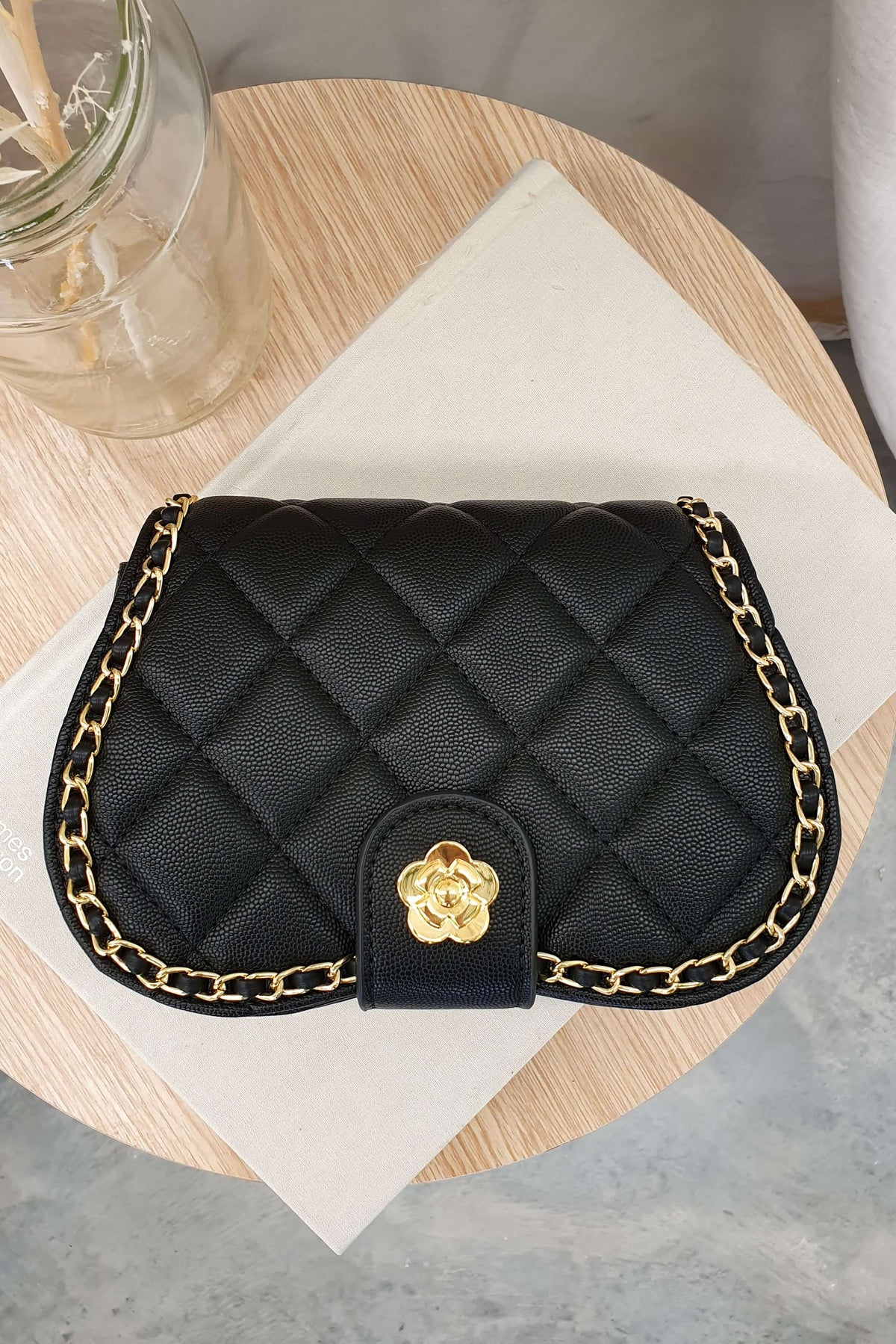Chic Vera Bag in quilted black vegan leather with gold chain, perfect accessory for stylish outfits.