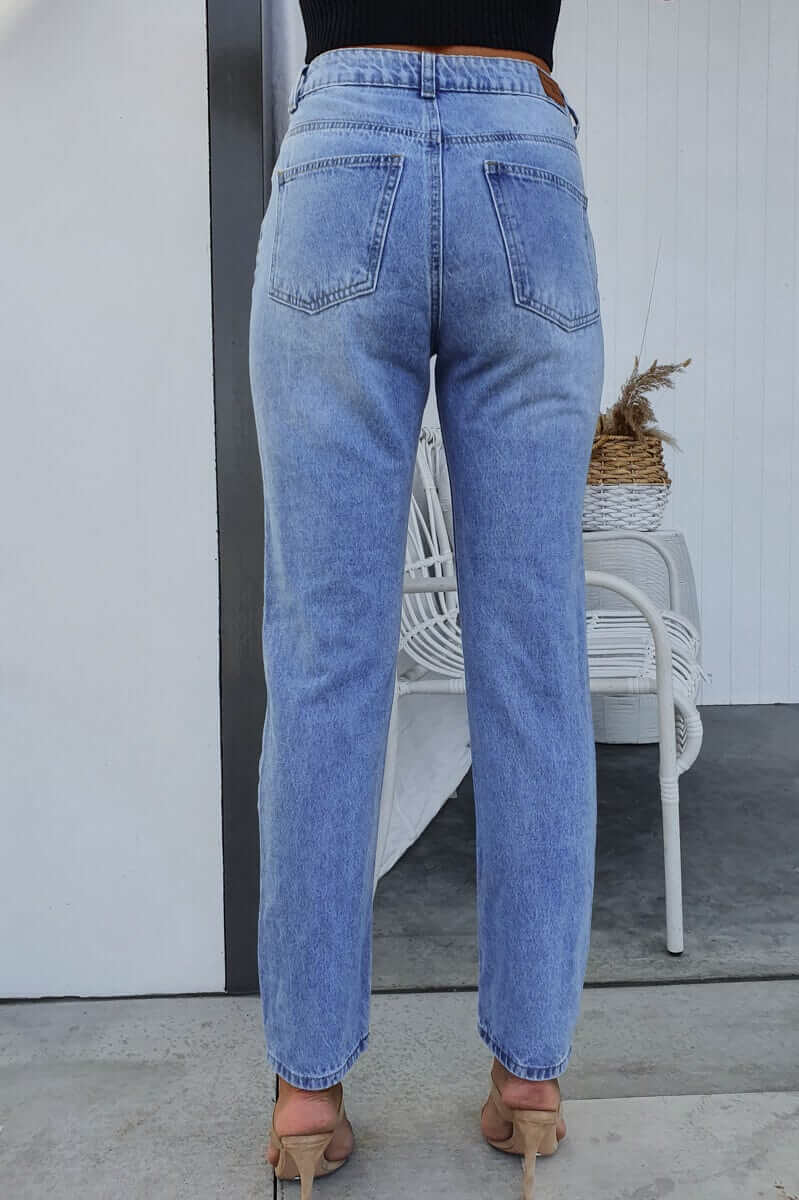 Back view of Pasha Mom Jeans in light blue denim, featuring a high waist and classic five-pocket design.