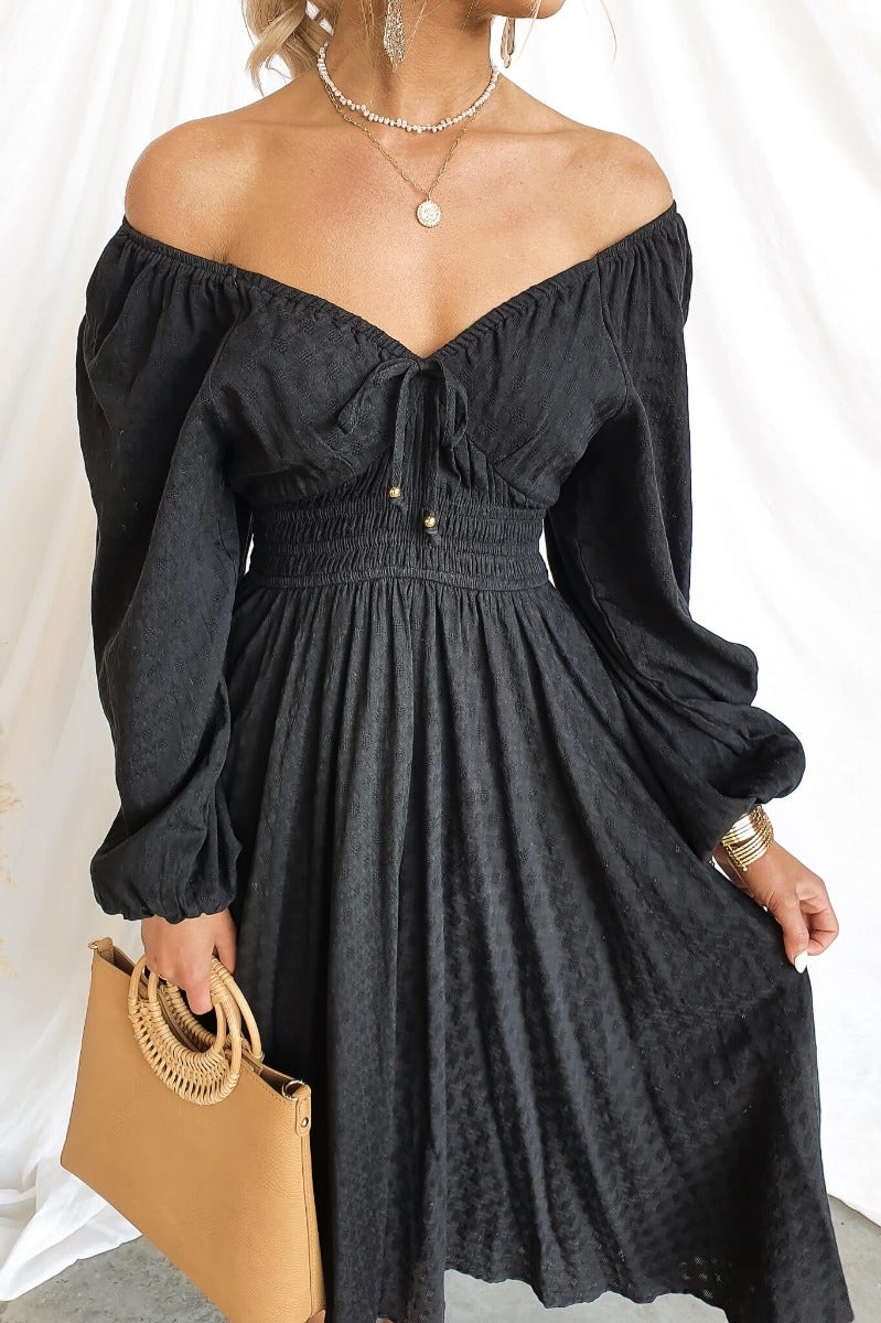 Hemingway Midi Dress: Black cotton dress with elastic fittings, off-shoulder design, and tie neckline detail.