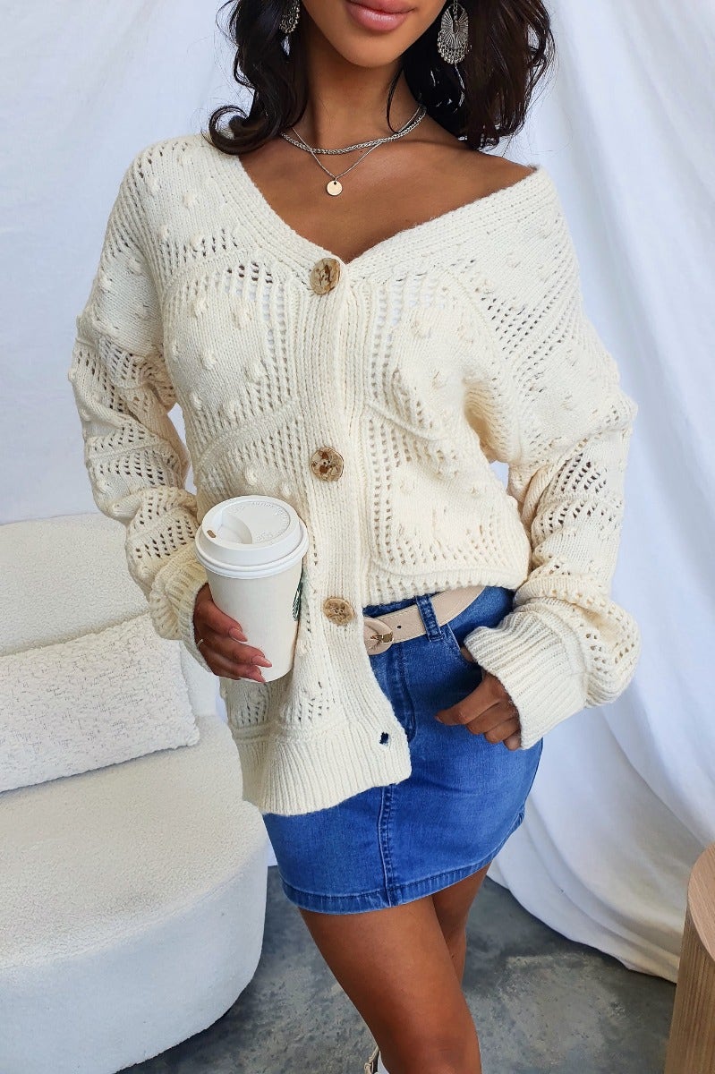 Azaria Cardigan: Textured knit V-neck cardigan with button-up front, worn casually with a denim skirt and coffee.