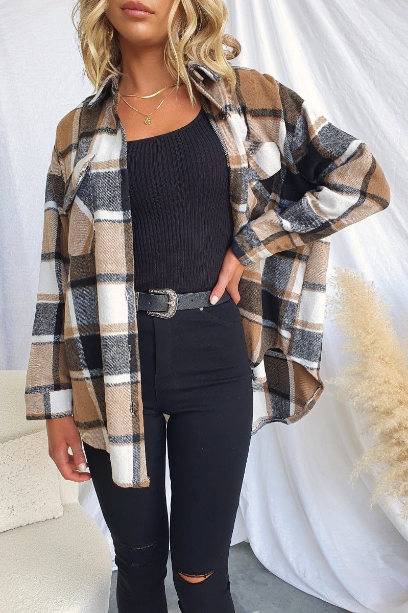 Model wearing a plaid print Gable shacket styled with black top and jeans, showcasing relaxed fit and button-up front.