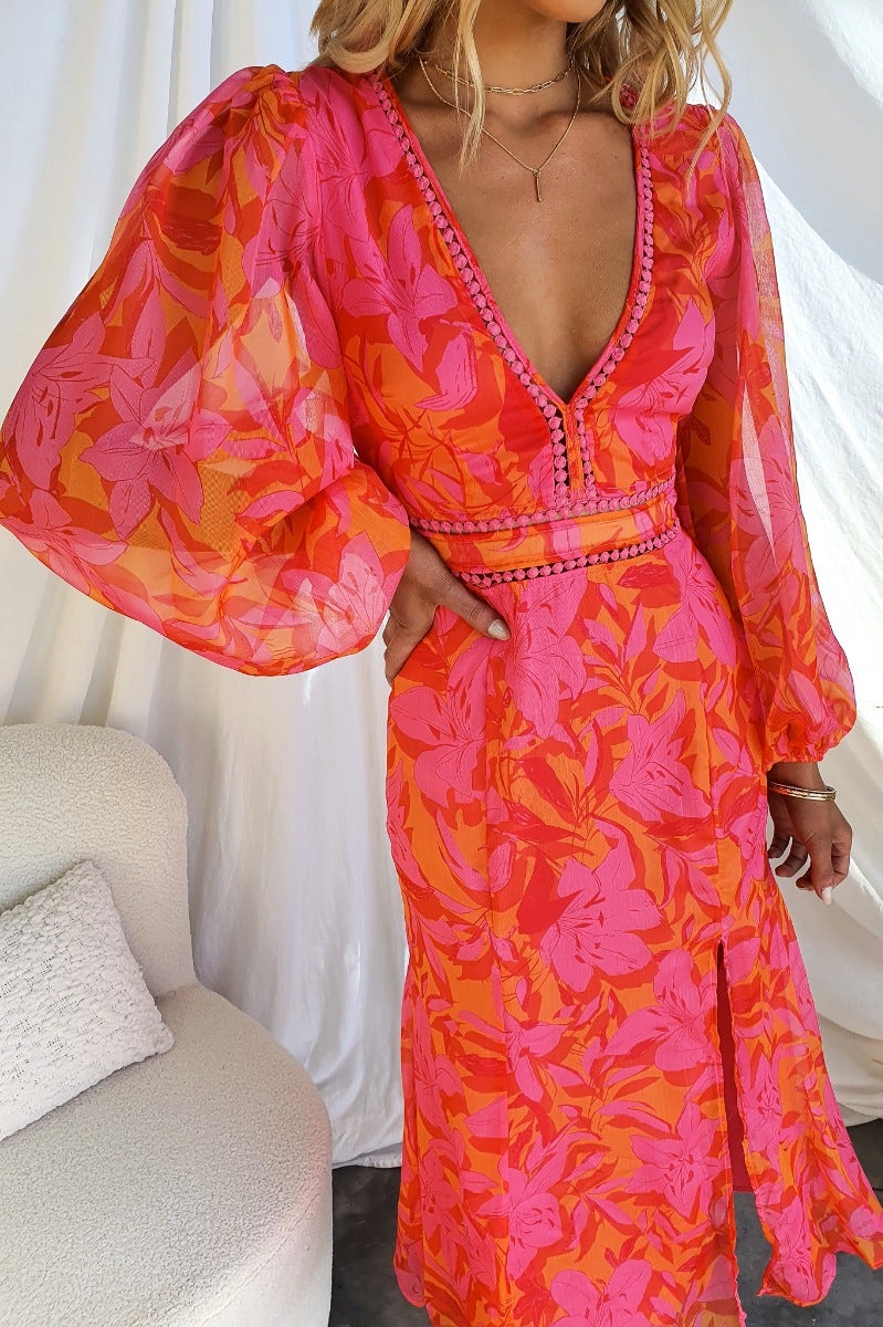 Zaida Midi Dress featuring a bright floral print, V-neckline, and puff sleeves, perfect for a stylish summer look.