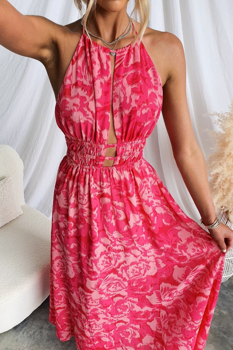 Model wearing a multi-colour Kariah Maxi Dress with adjustable halter neckline and cut-outs at bust.
