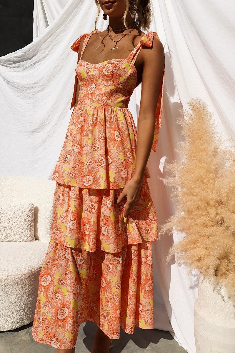 Floral print Connali maxi dress featuring adjustable tie straps and tiered layers, perfect for summer outings.